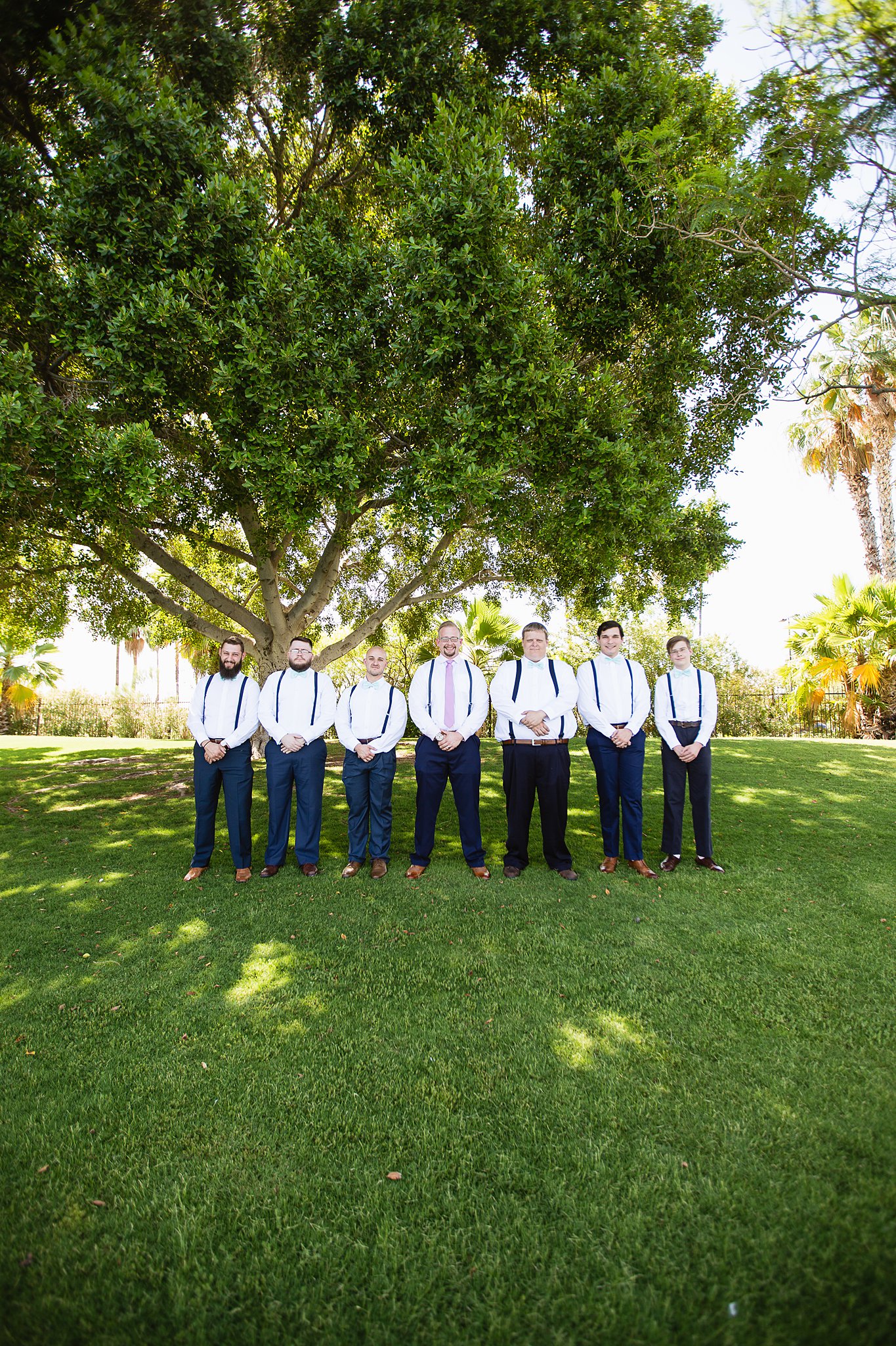 Groom and groomsmen together at a Val Vista Lakes wedding by Arizona wedding photographer PMA Photography.