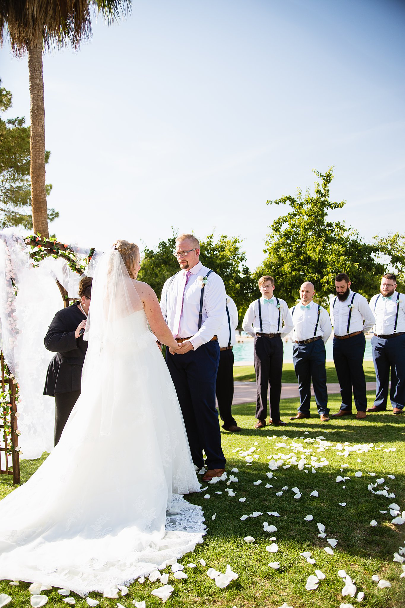 Wedding ceremony at Val Vista Lakes by Arizona wedding photographer PMA Photography.