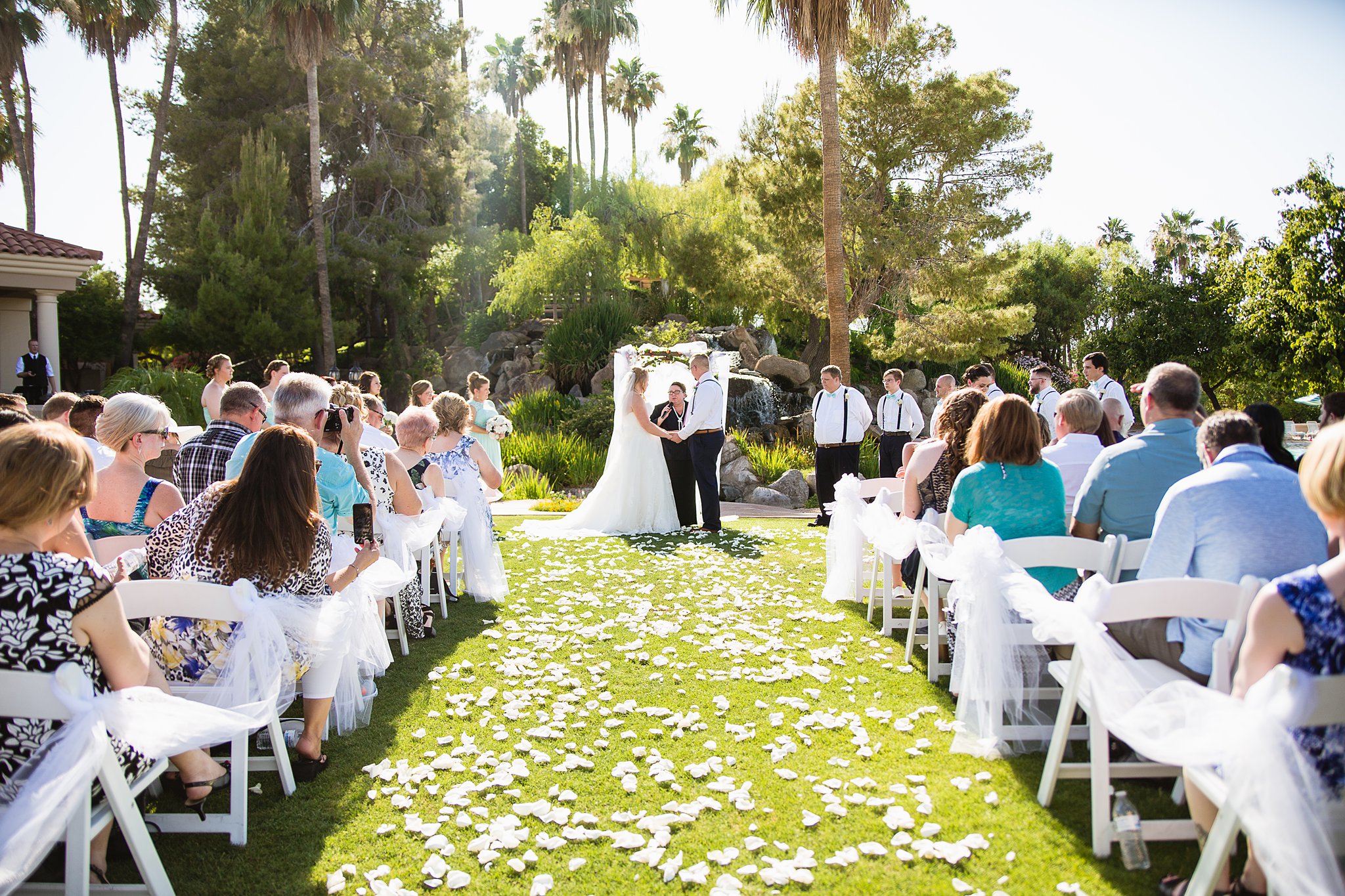 Wedding ceremony at Val Vista Lakes by Arizona wedding photographer PMA Photography.