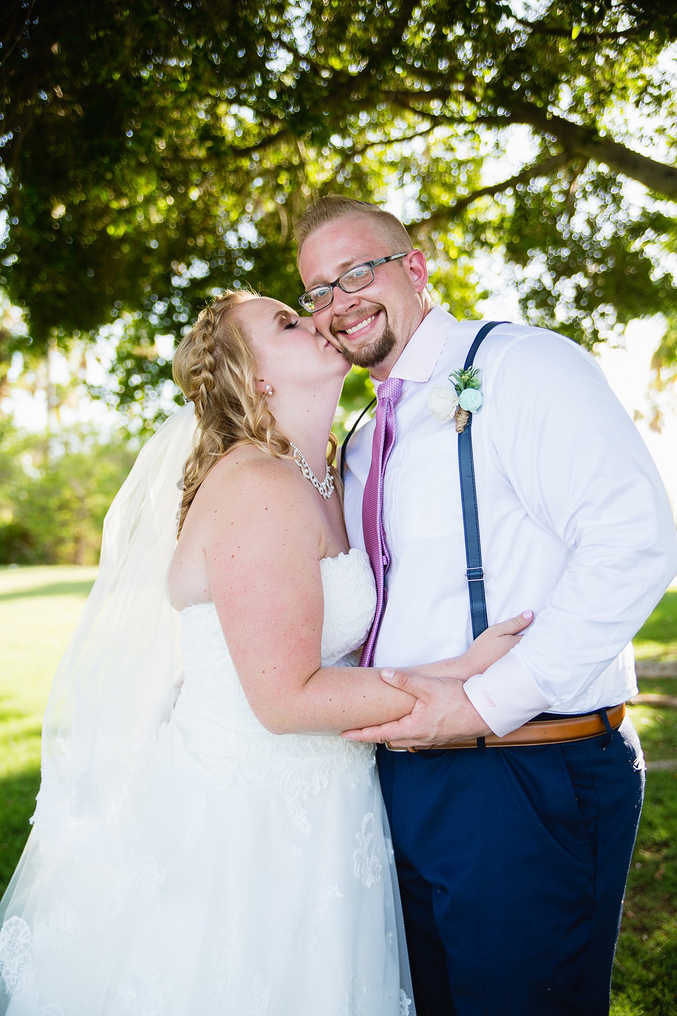 Bride and groom pose for their Val Vista Lakes wedding by Gilbert wedding photographer PMA Photography.