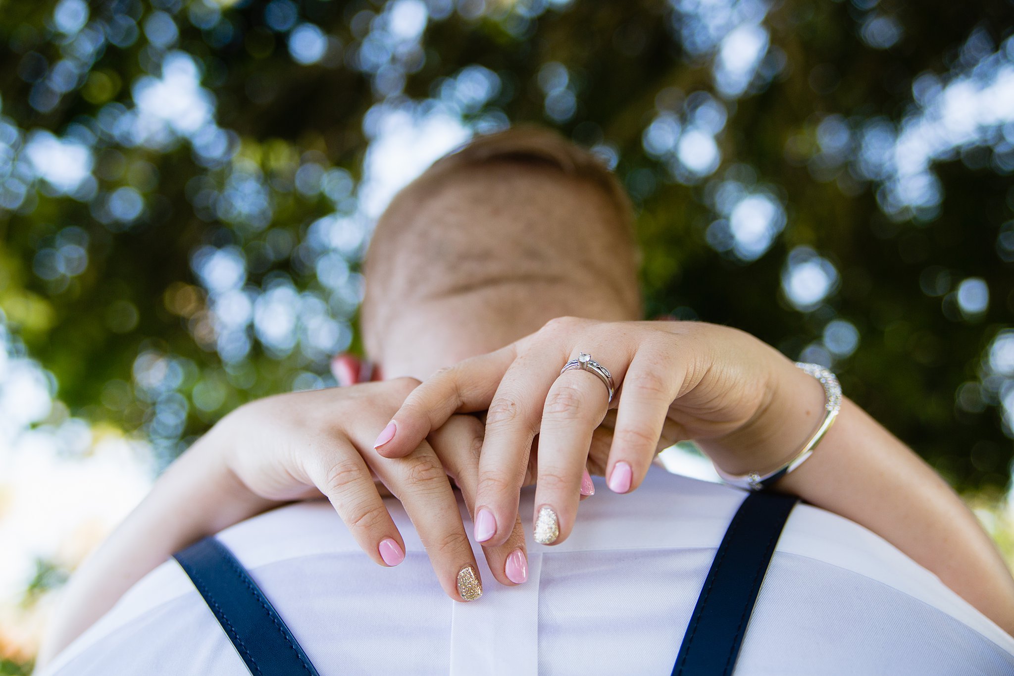 Simple wedding ring on bride's hand by PMA Photography.