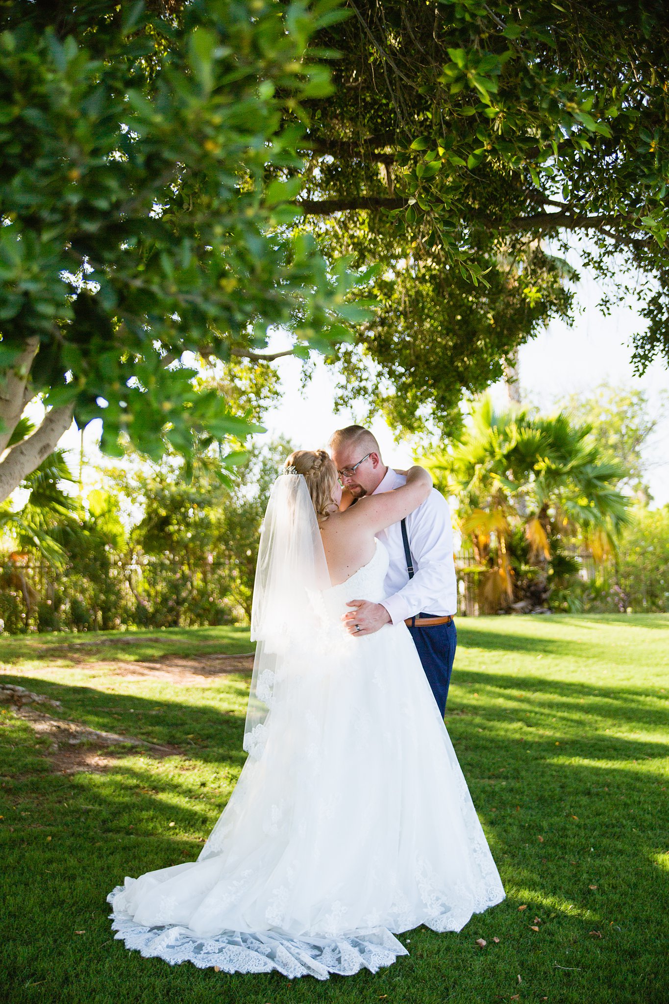 Bride and groom share an intimate moment during their Val Vista Lakes wedding by Gilbert engagement photographer PMA Photography.