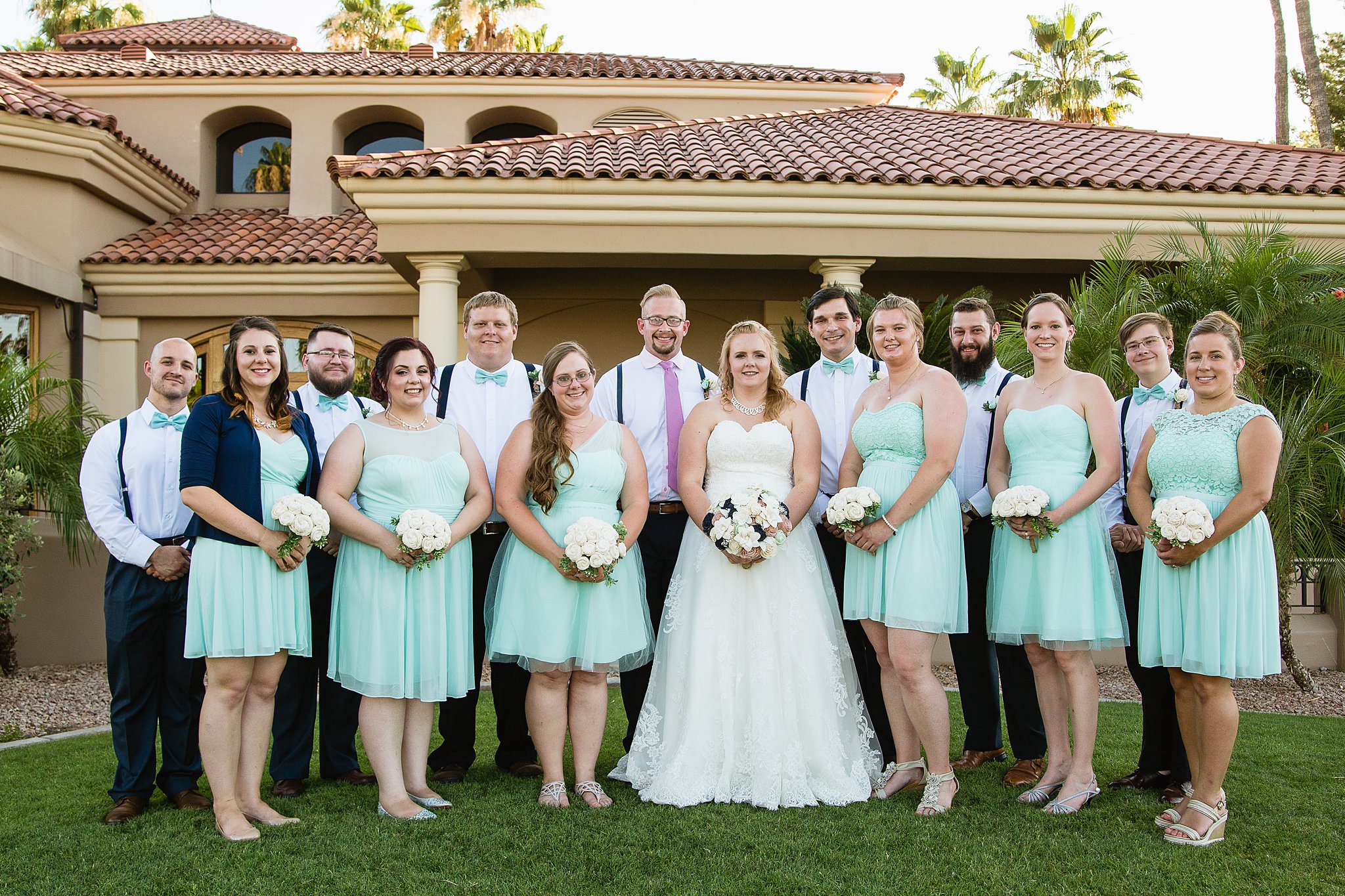 Bridal party together at a Val Vista Lakes wedding by Arizona wedding photographer PMA Photography.