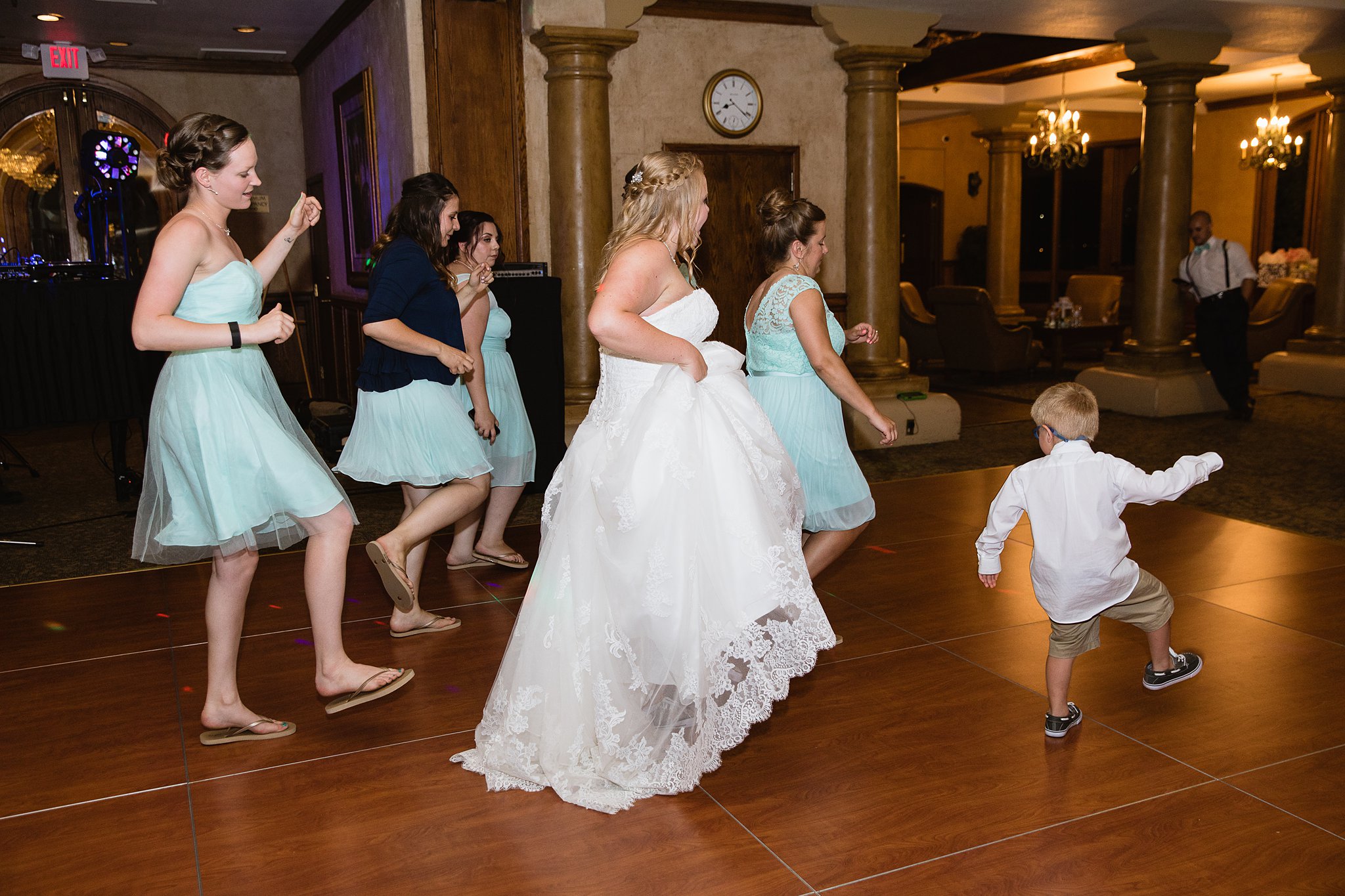 Bride dancing with guests at Val Vista Lakes wedding reception by Gilbert wedding photographer PMA Photography