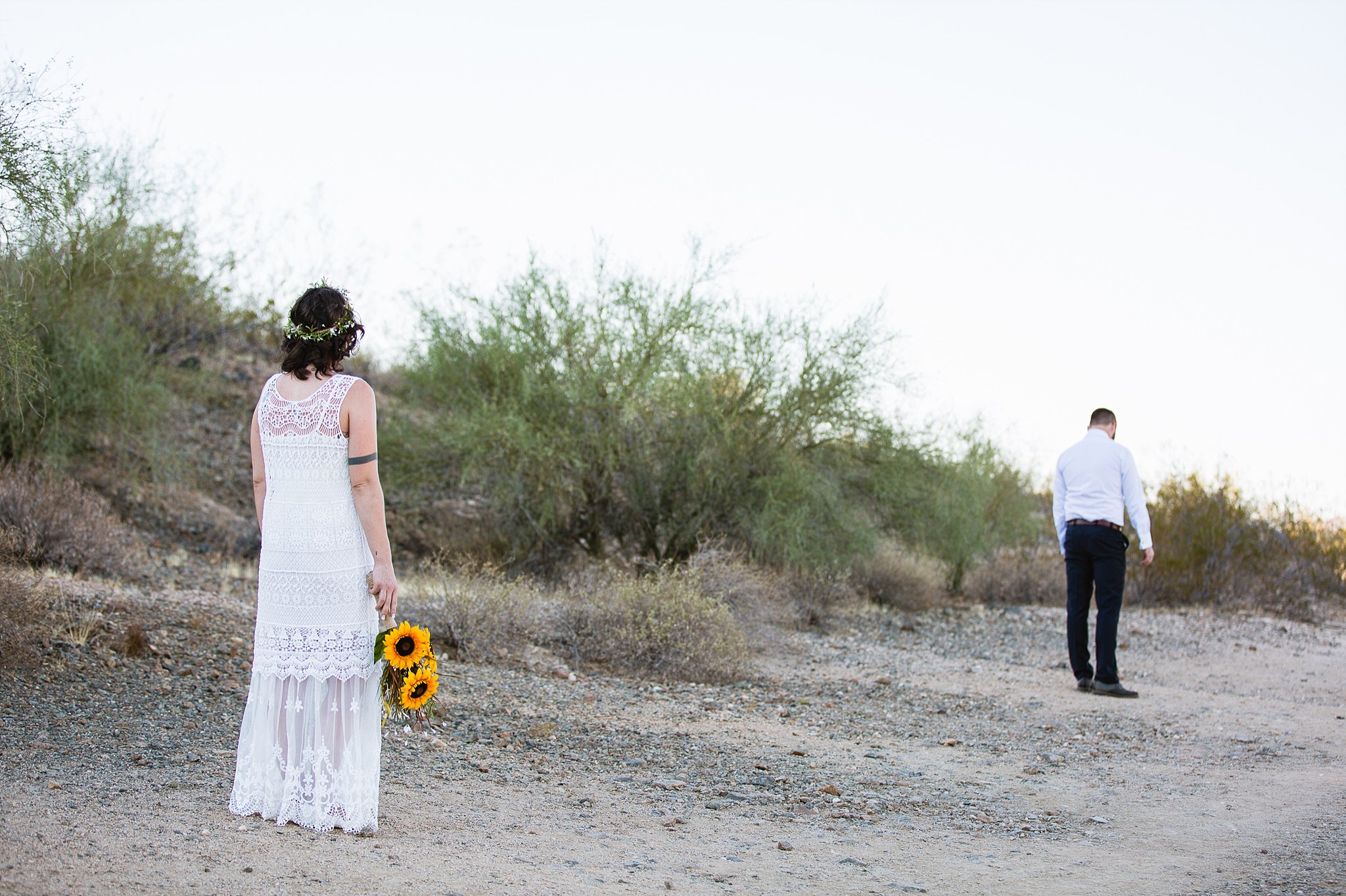 Simple boho bride and groom get ready for their first look in the desert by Arizona wedding photographer PMA Photography.