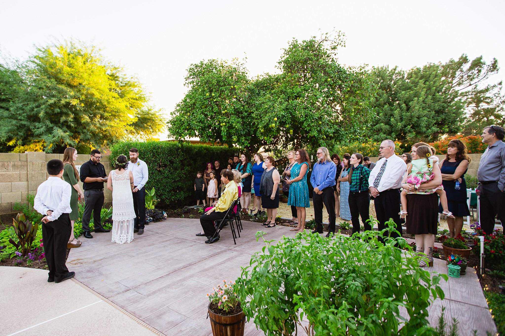 Small intimate backyard garden wedding ceremony by Phoenix wedding photographer PMA Photography.