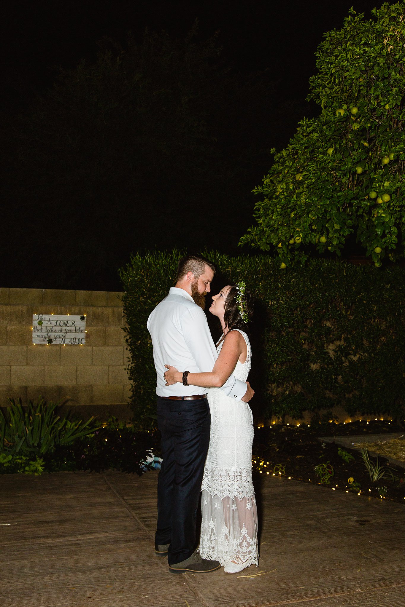 Bride and groom share their first dance at their backyard garden wedding by Arizona wedding photographer PMA Photography.