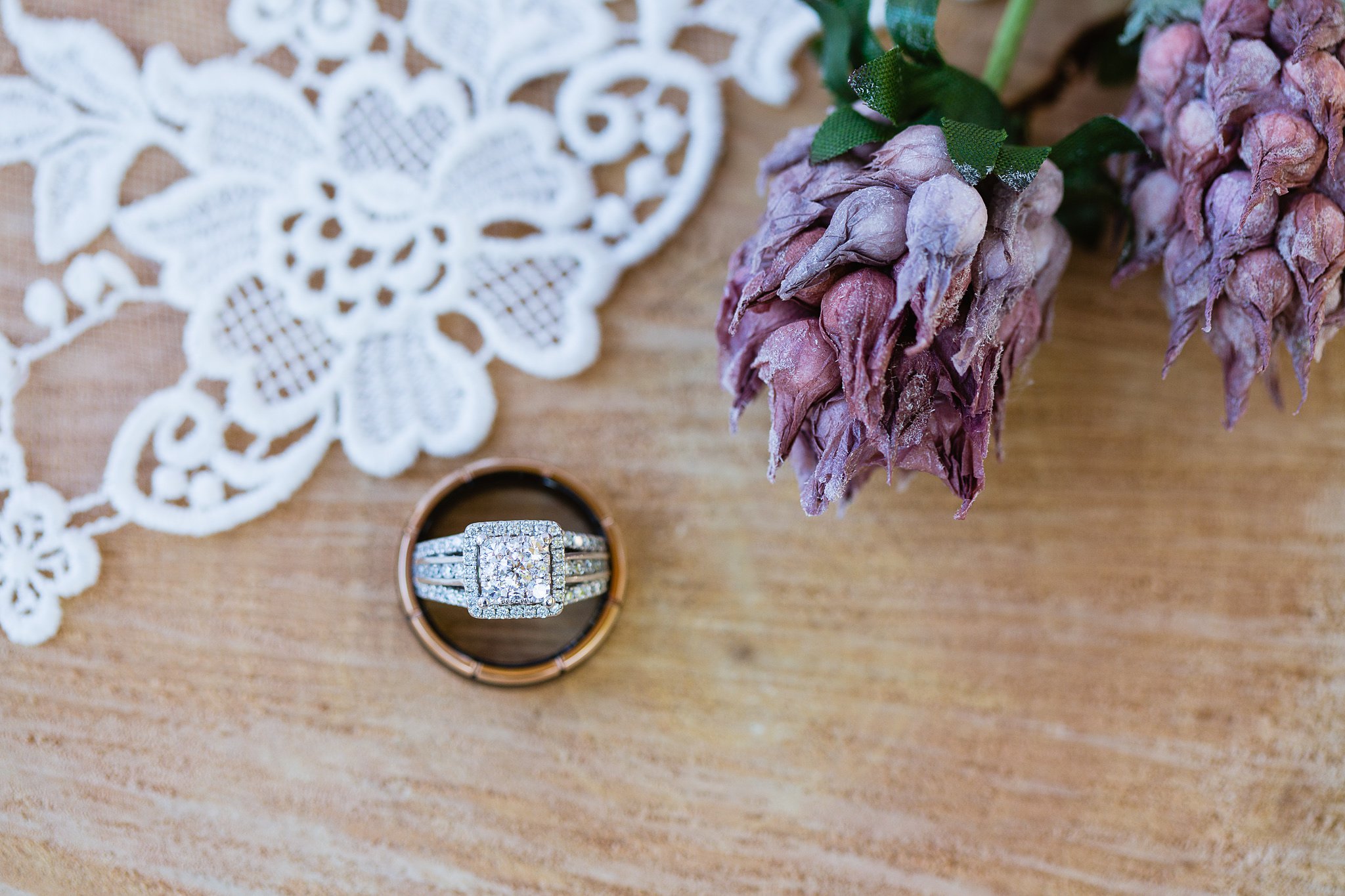 Bride and groom's wedding rings with rustic purple details by wedding photographer PMA Photography.
