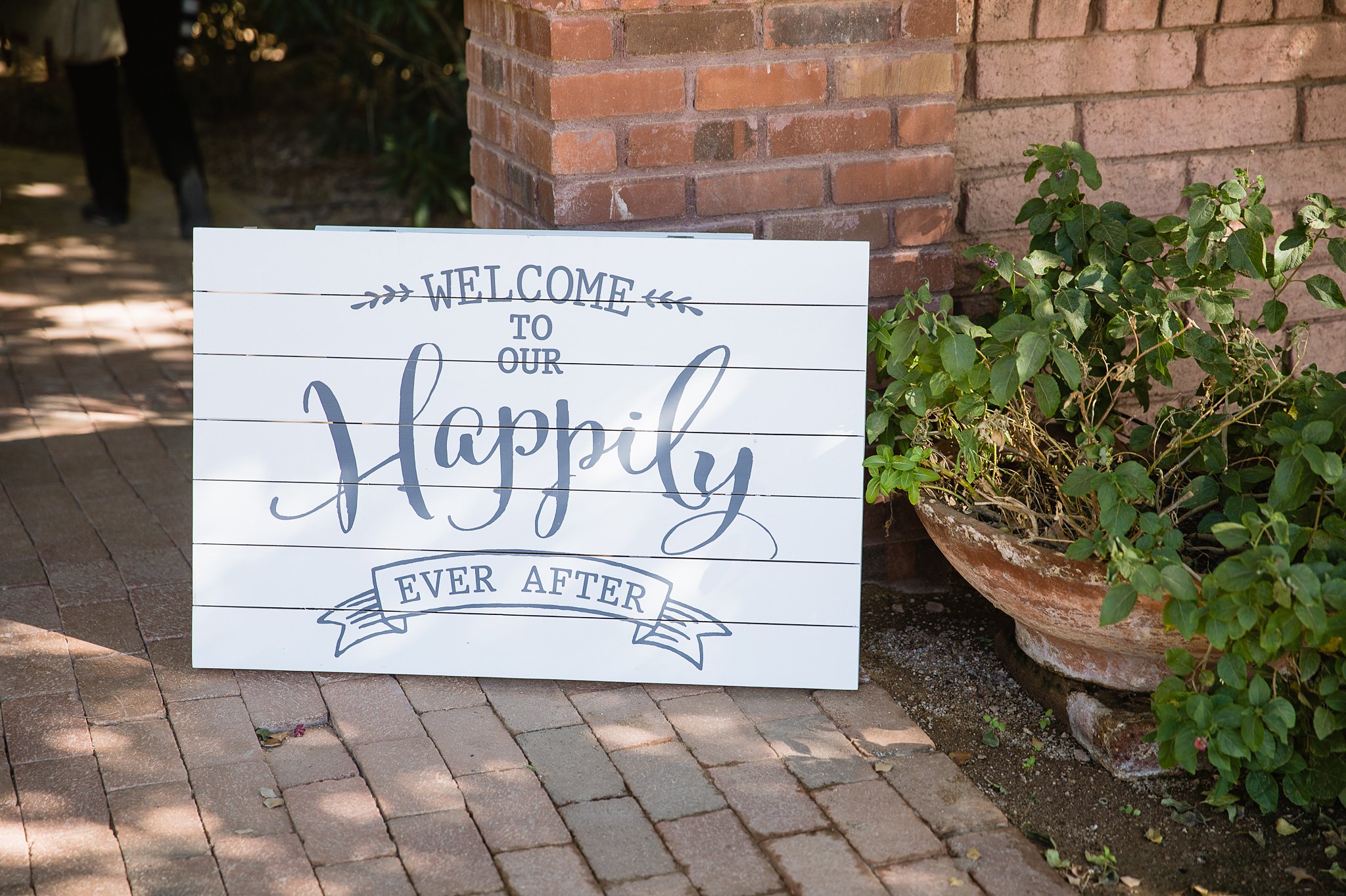 "Welcome to our happily ever after" rustic wedding sign by PMA Photography.
