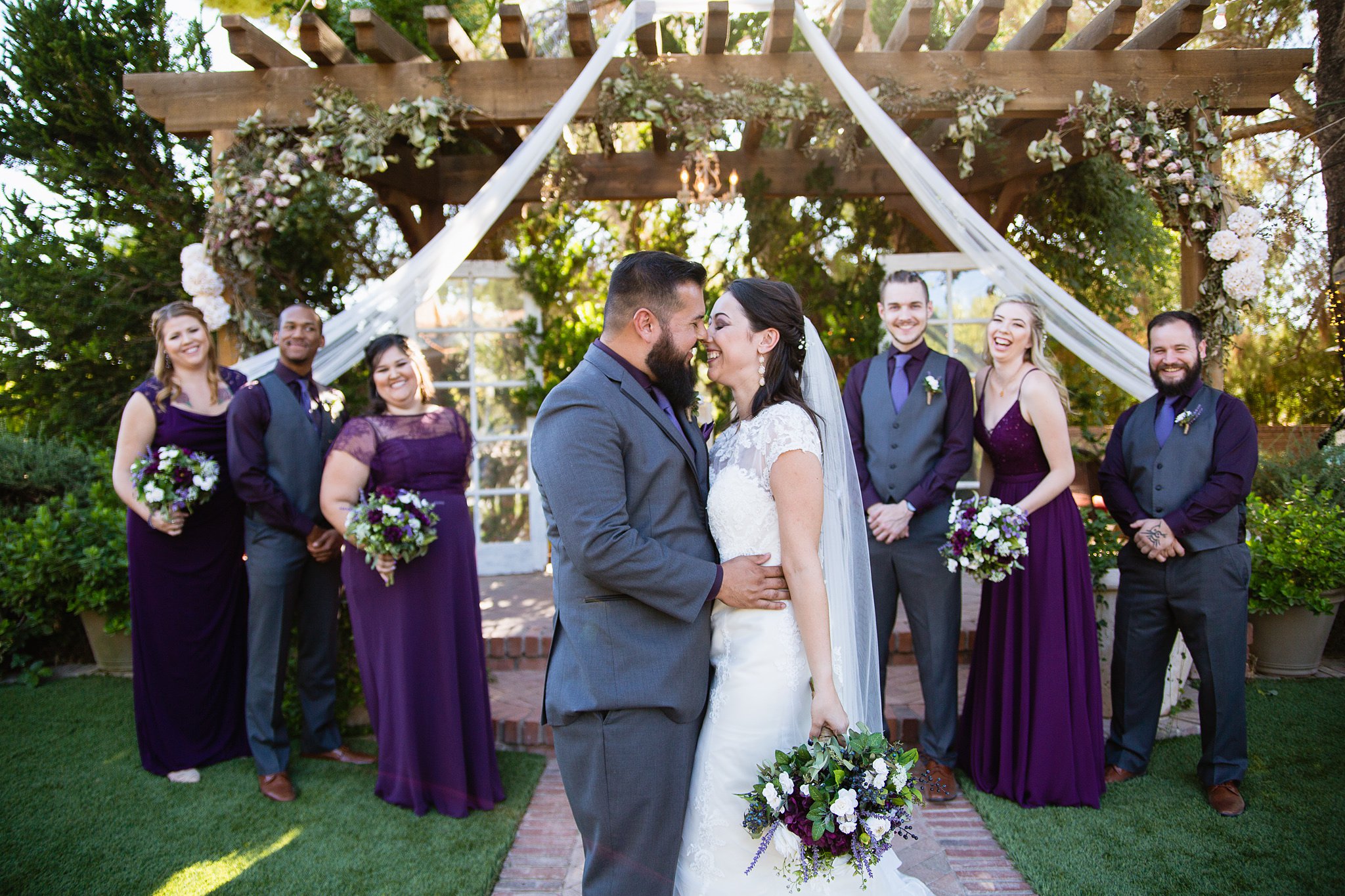 Bride and groom with bridal party at their purple and grey rustic wedding at Schnepf Farms by Arizona wedding photographer PMA Photography.