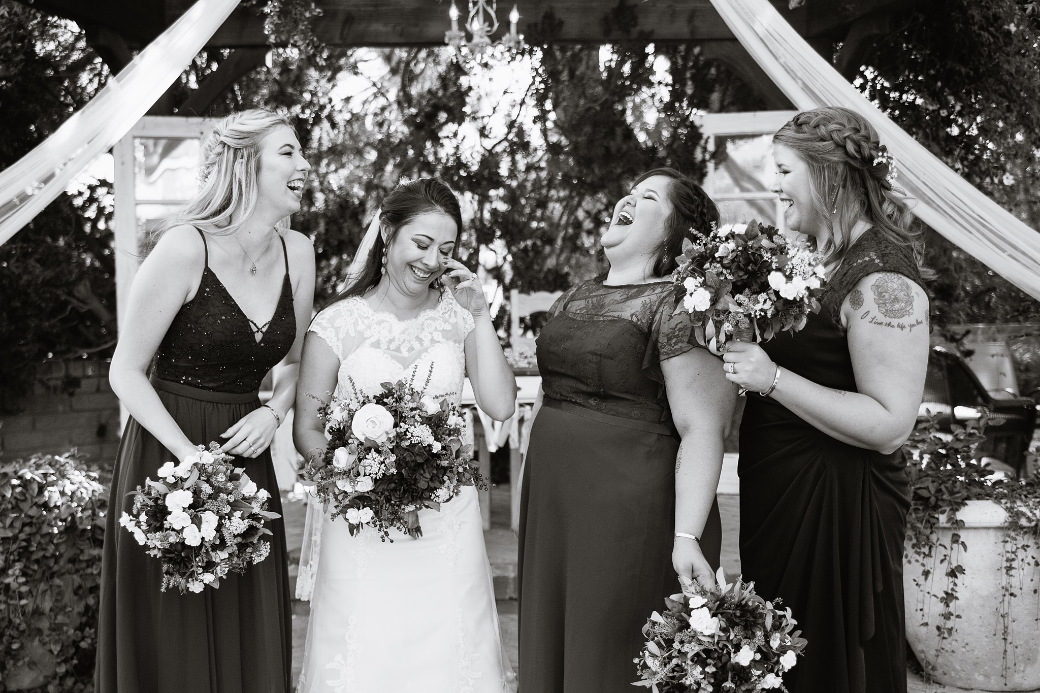 Black and white images of bridesmaids laughing with bride by Phoenix wedding photographer PMA Photography.