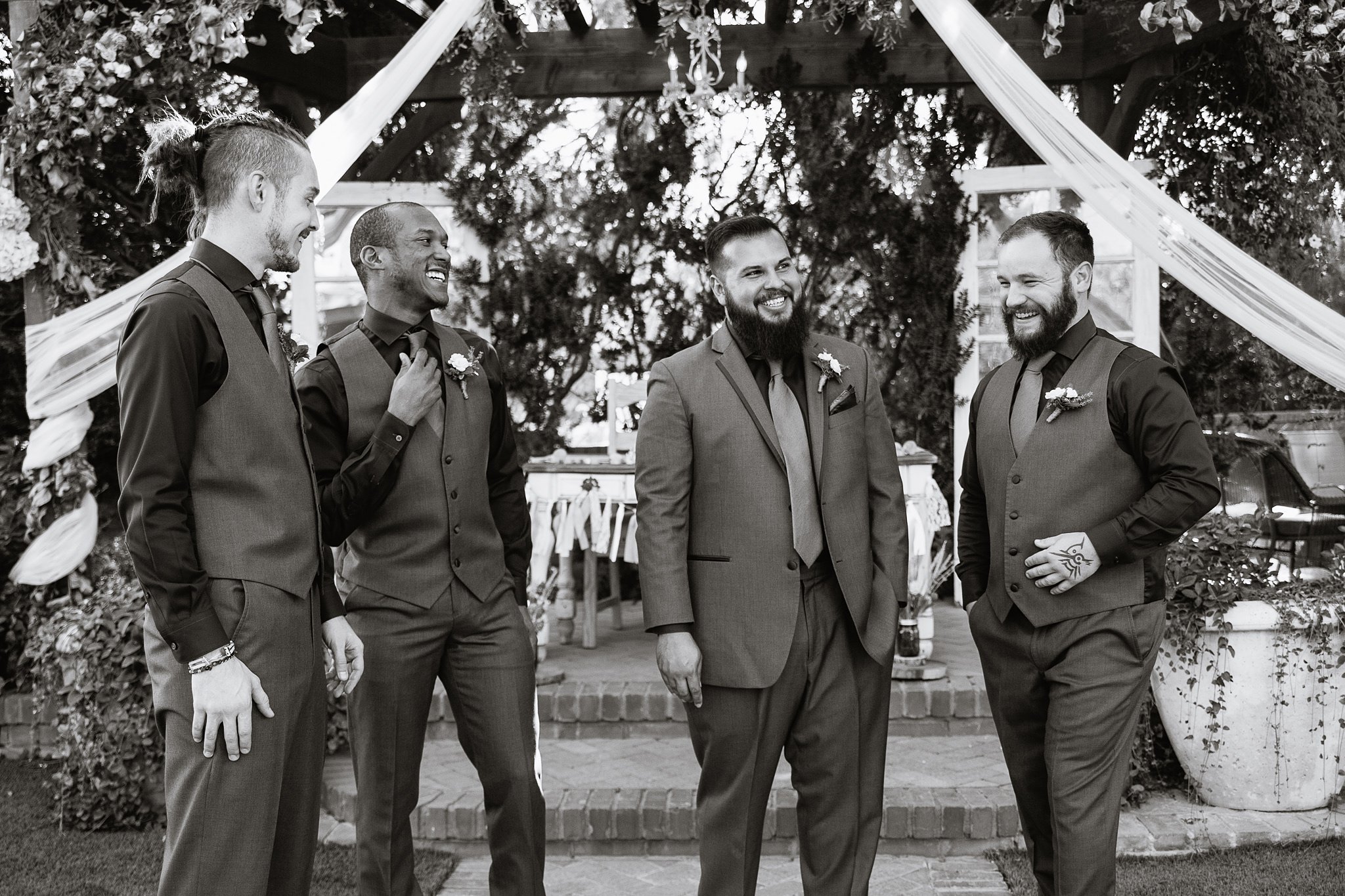 Black and white images of groomsmen laughing with groom by Arizona wedding photographer PMA Photography.