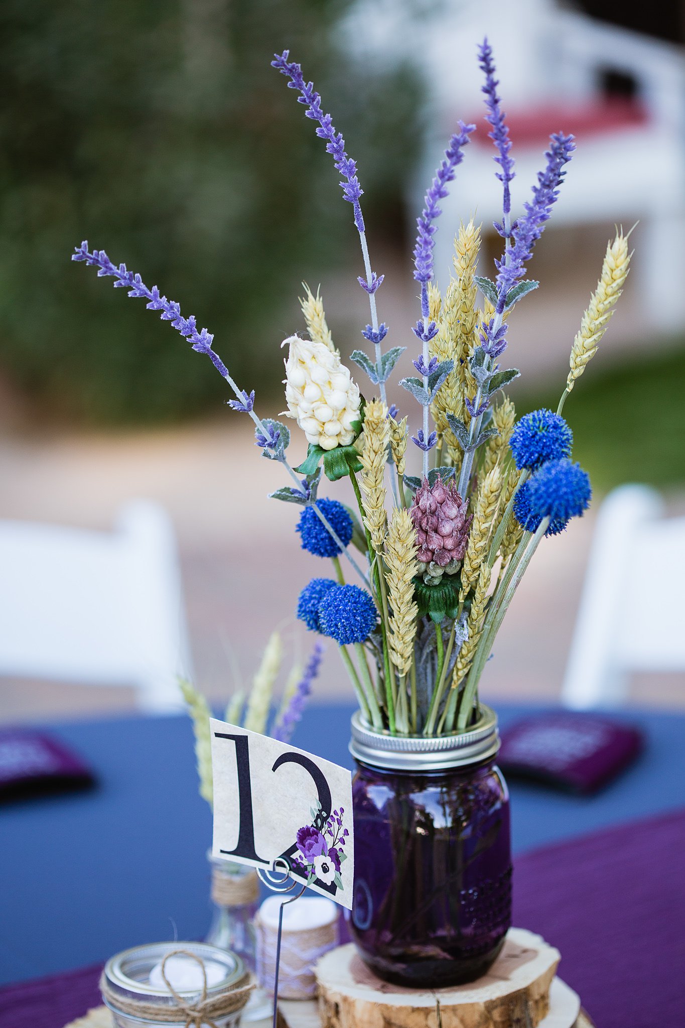 Rustic chic purple wedding reception centerpiece at Schnepf Farms by Arizona wedding photographer PMA Photography.