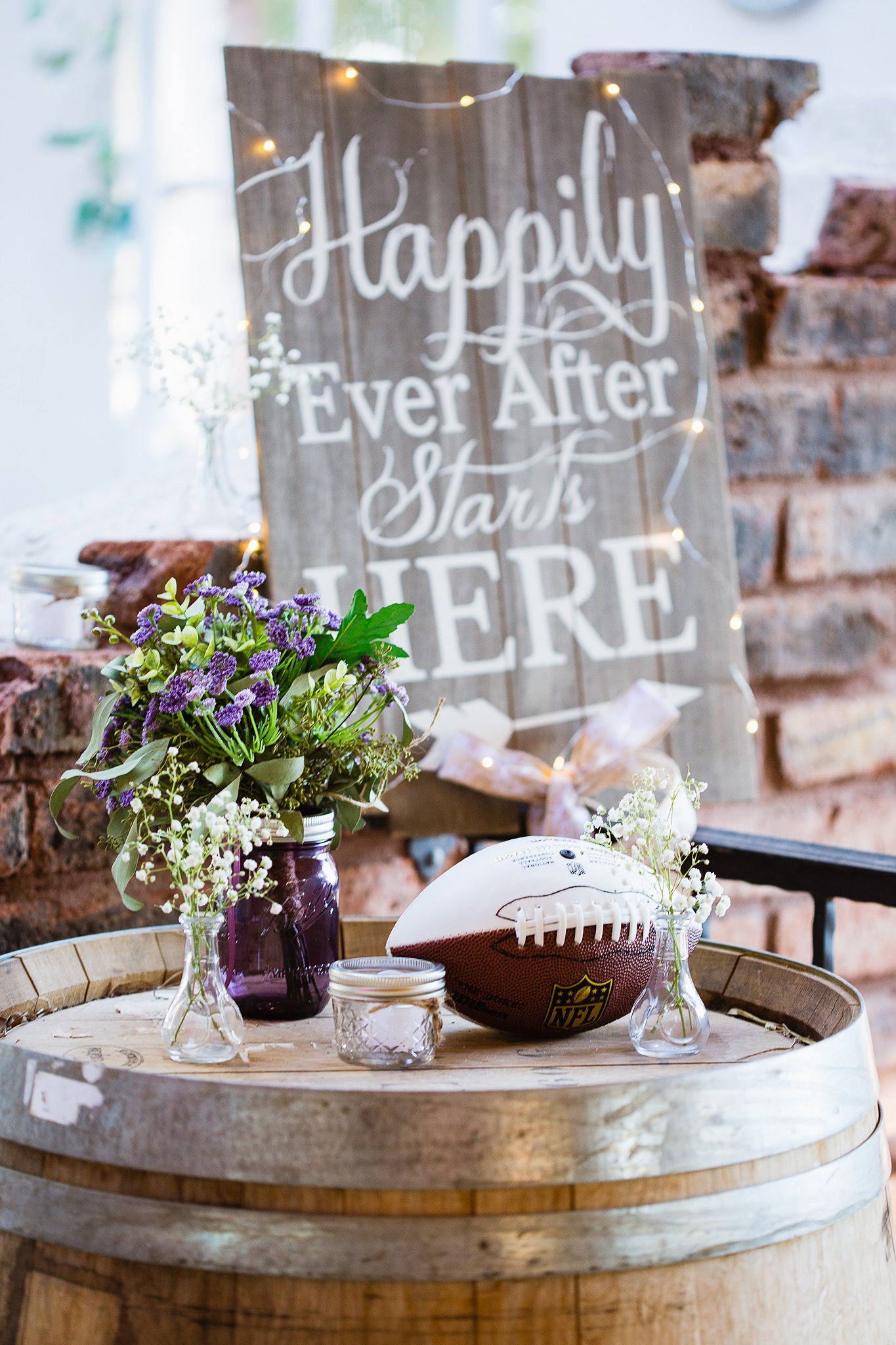 Toss bouquet and football for garter toss at rustic chic wedding reception by Phoenix wedding photographer PMA Photography.