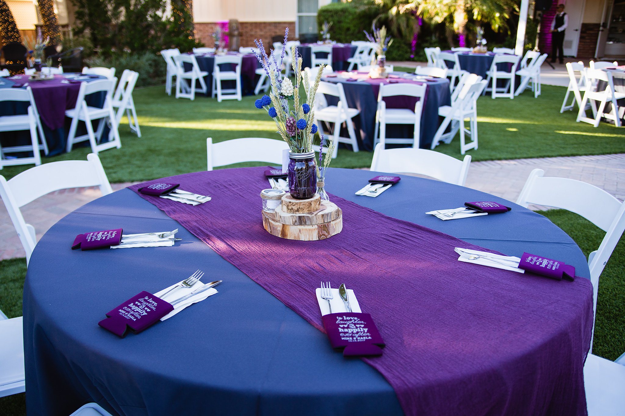 Rustic chic purple wedding reception decorations at Schnepf Farms by Arizona wedding photographer PMA Photography.