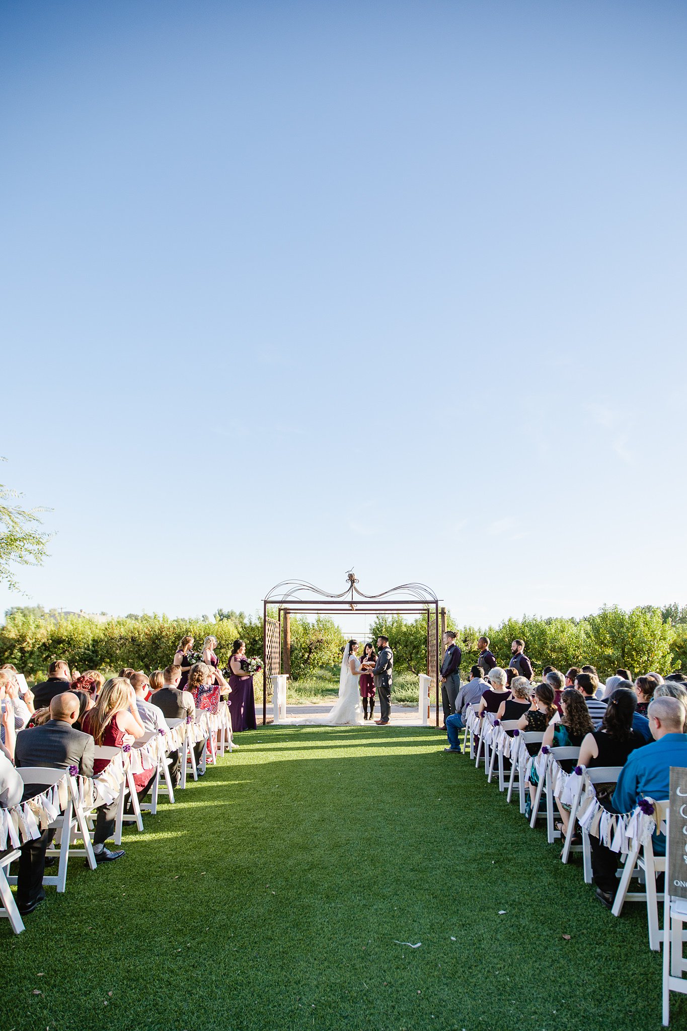 Fall wedding ceremony at the Schnepf Farm's Farmhouse orchard by Arizona wedding photographer PMA Photography.