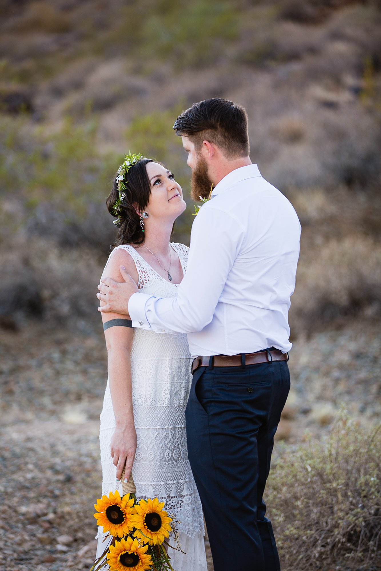 Boho bride and groom during their wedding first look in the Arizona desert by Phoenix wedding photographers PMA Photography.