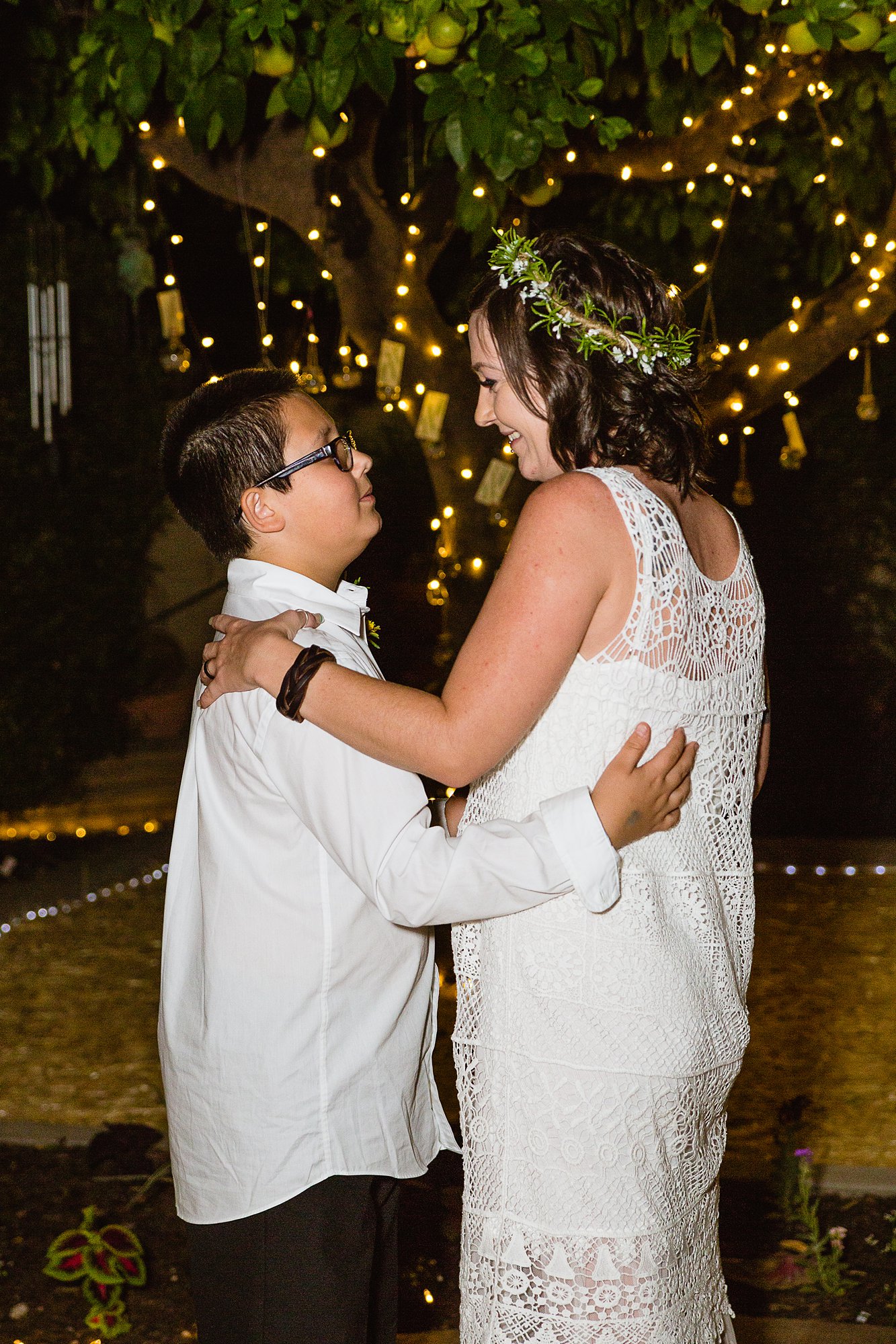 Bride and her son sharing the mother son dance at their wedding by Phoenix wedding photographer PMA Photography.