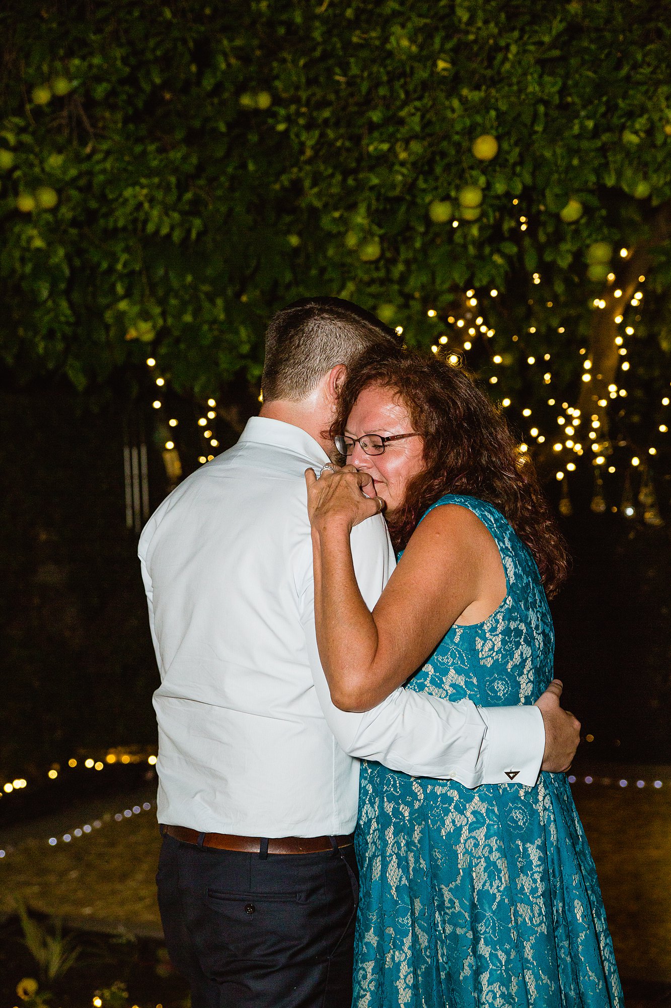 Groom sharing a dance with this mom during the mother son dance by Phoenix wedding photographer PMA Photography.