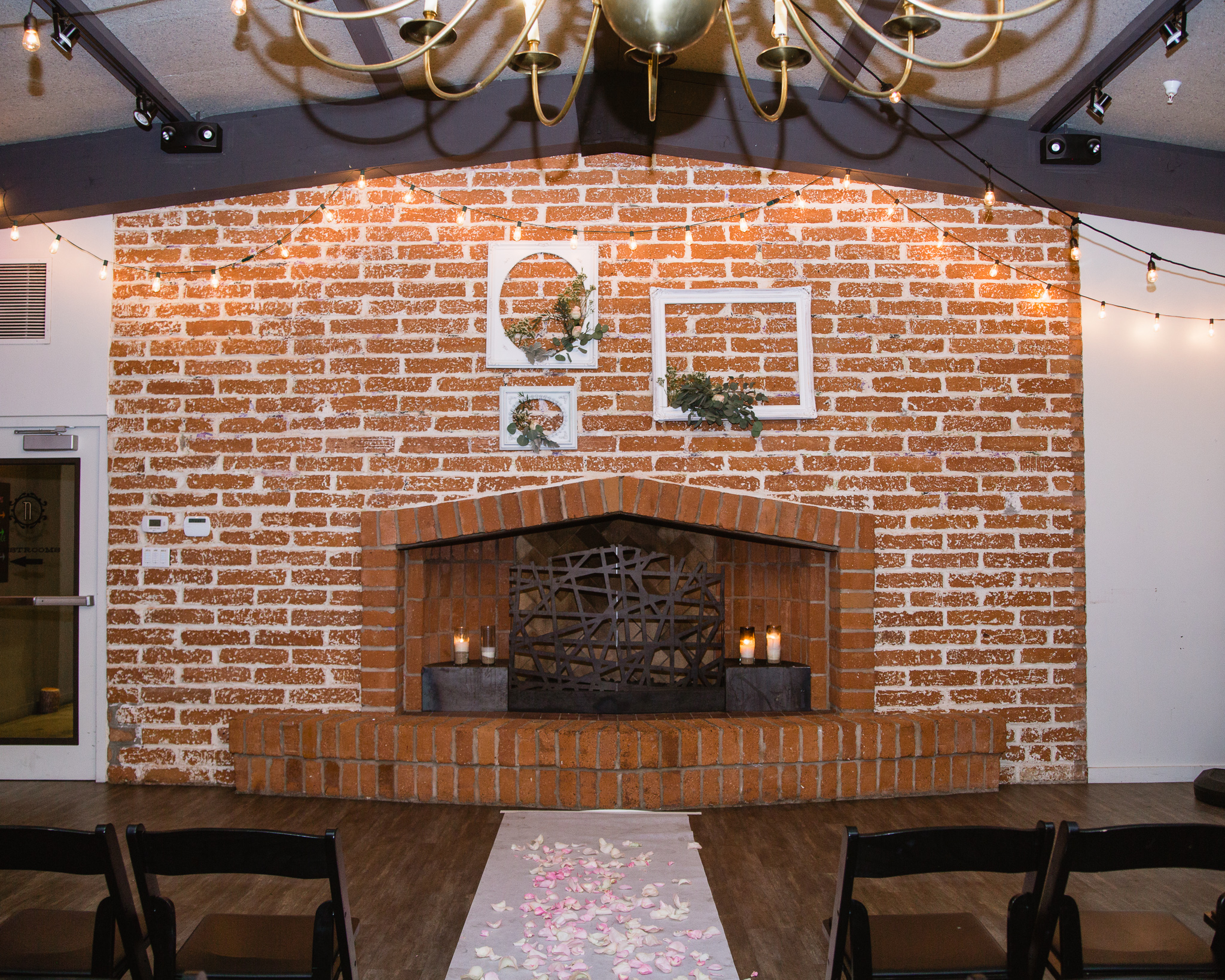 Vintage brick wall and fireplace wedding ceremony backdrop at The Newton in Phoenix Arizona.