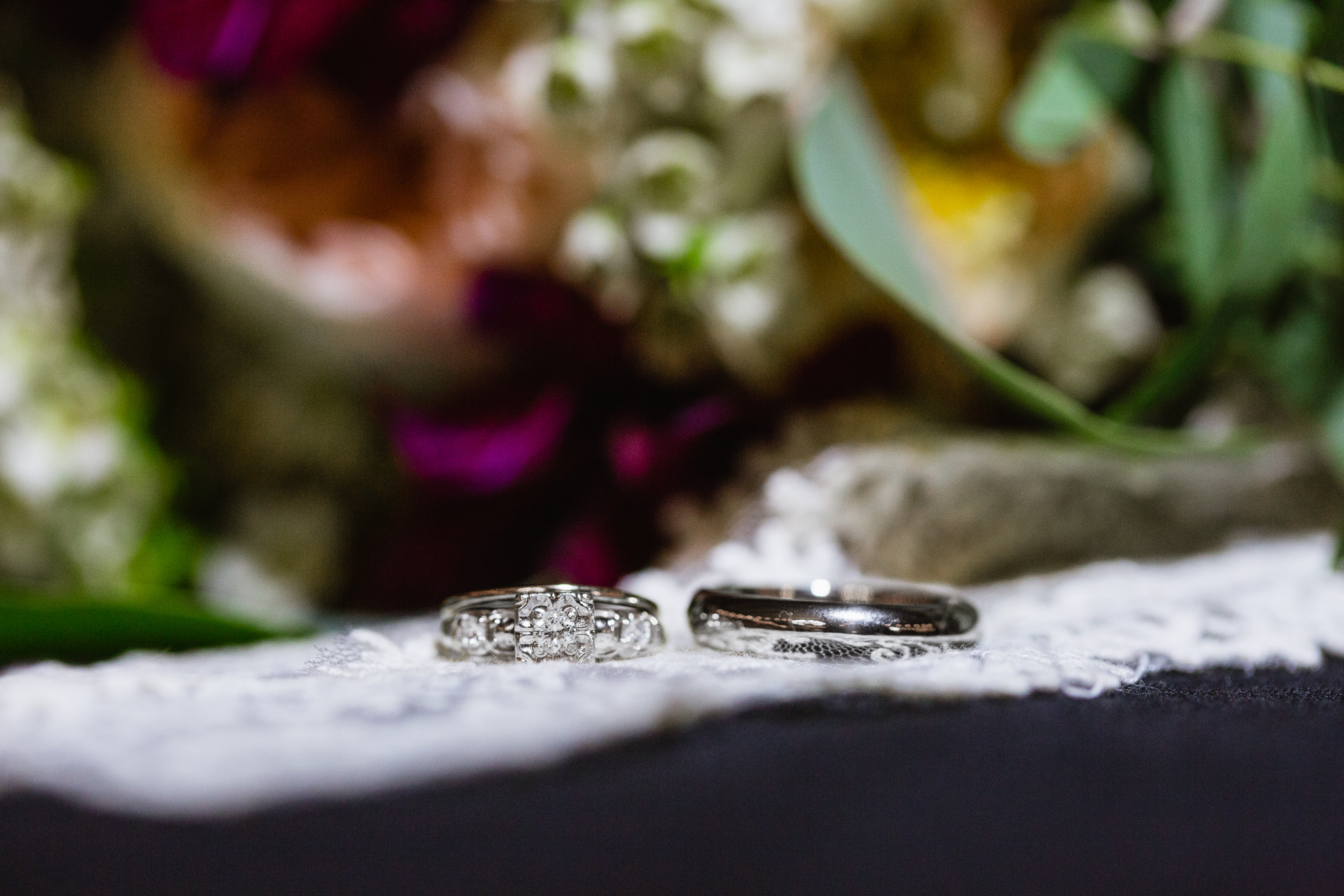 Close of up of vintage wedding rings on a piece of lace.