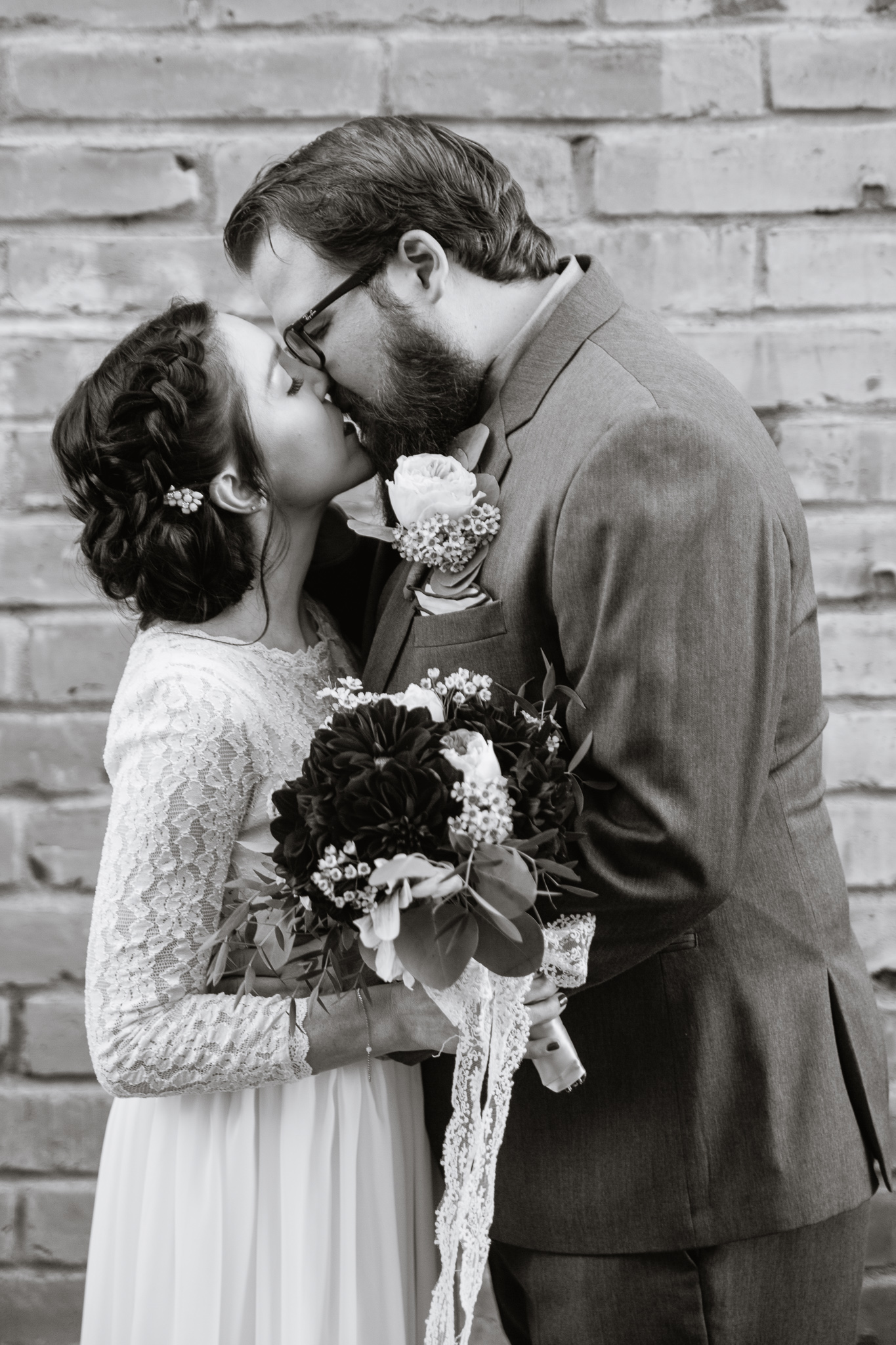 Black and white image of vintage inspired bride and groom kissing.