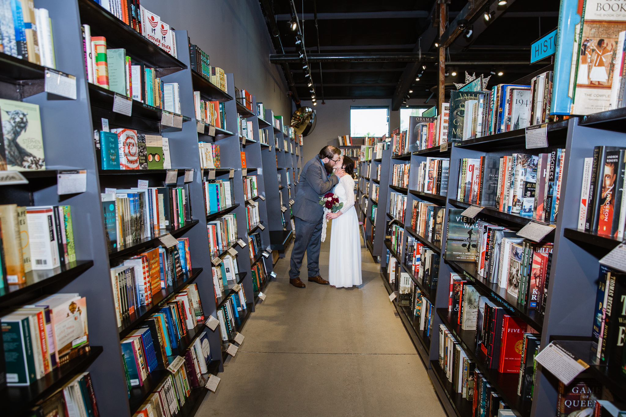 Vintage inspired bride and groom in Changing Hands bookstore at their book themed wedding in downtown Phoenix.