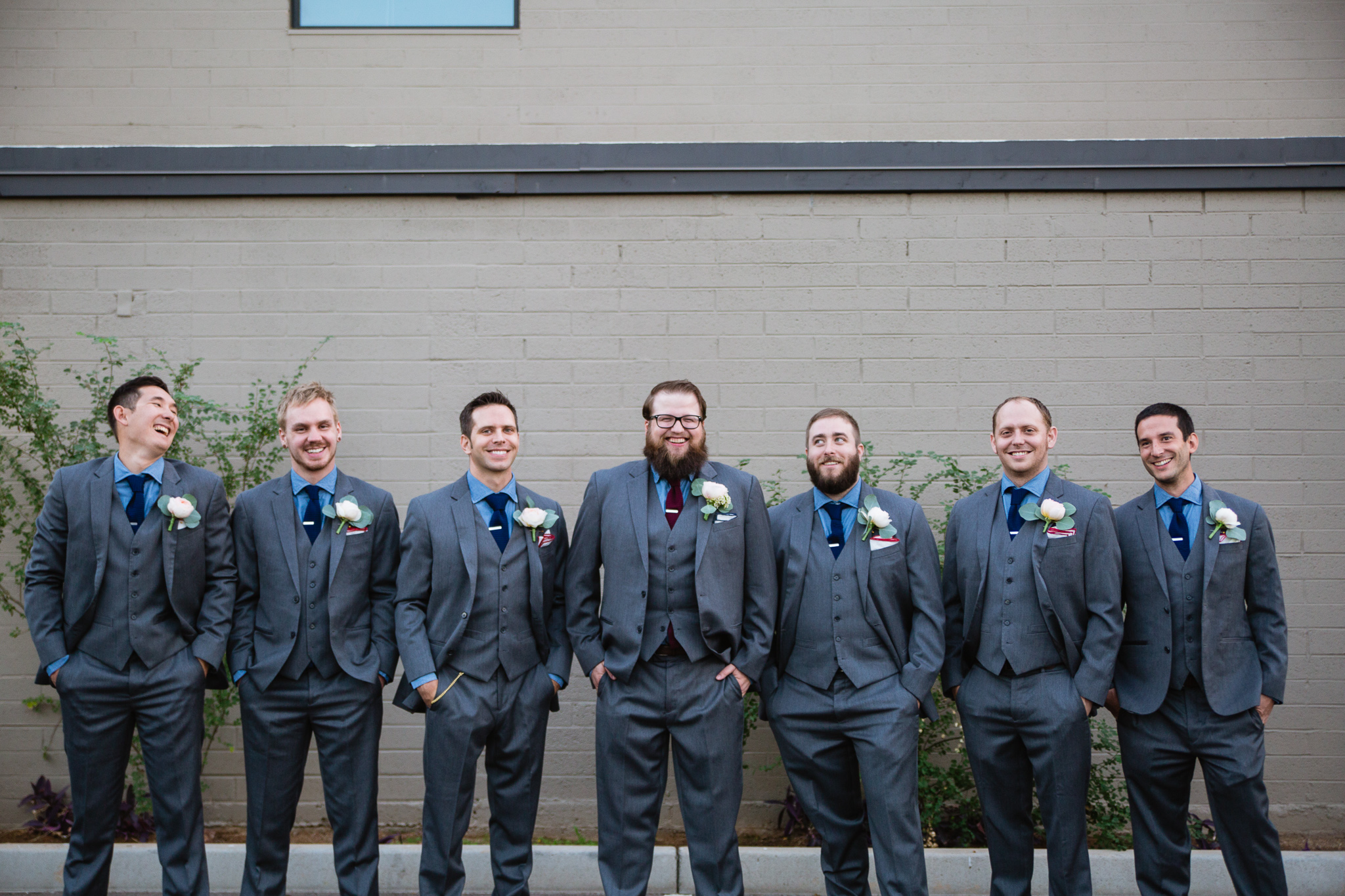 Grey blue and maroon themed groomsmen at a vintage book themed wedding day.