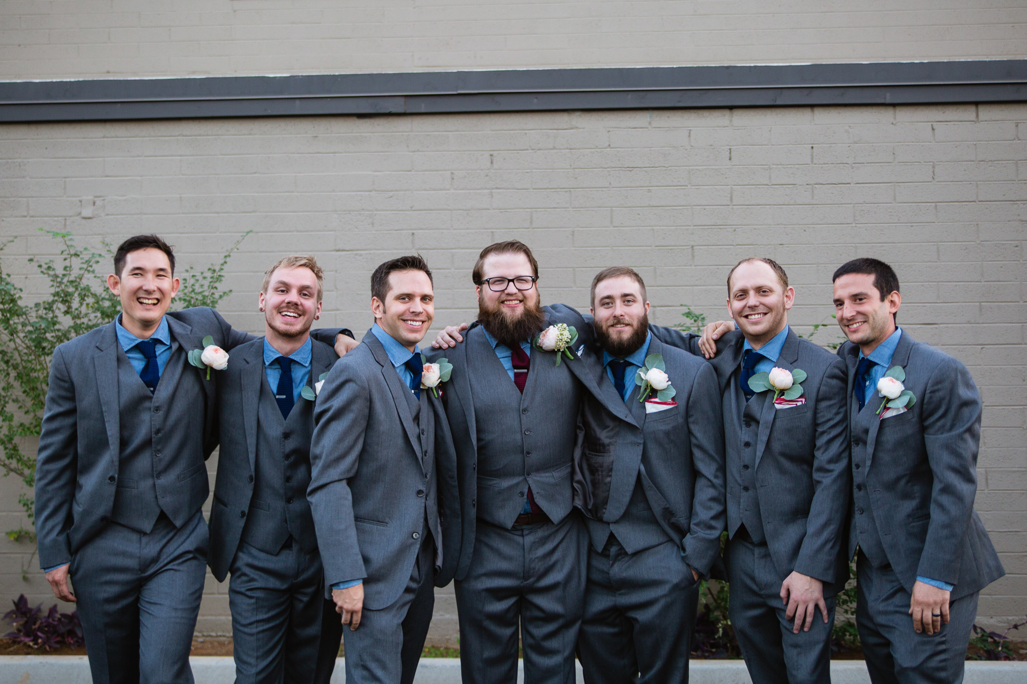 Grey blue and maroon themed groomsmen at a vintage book themed wedding day.