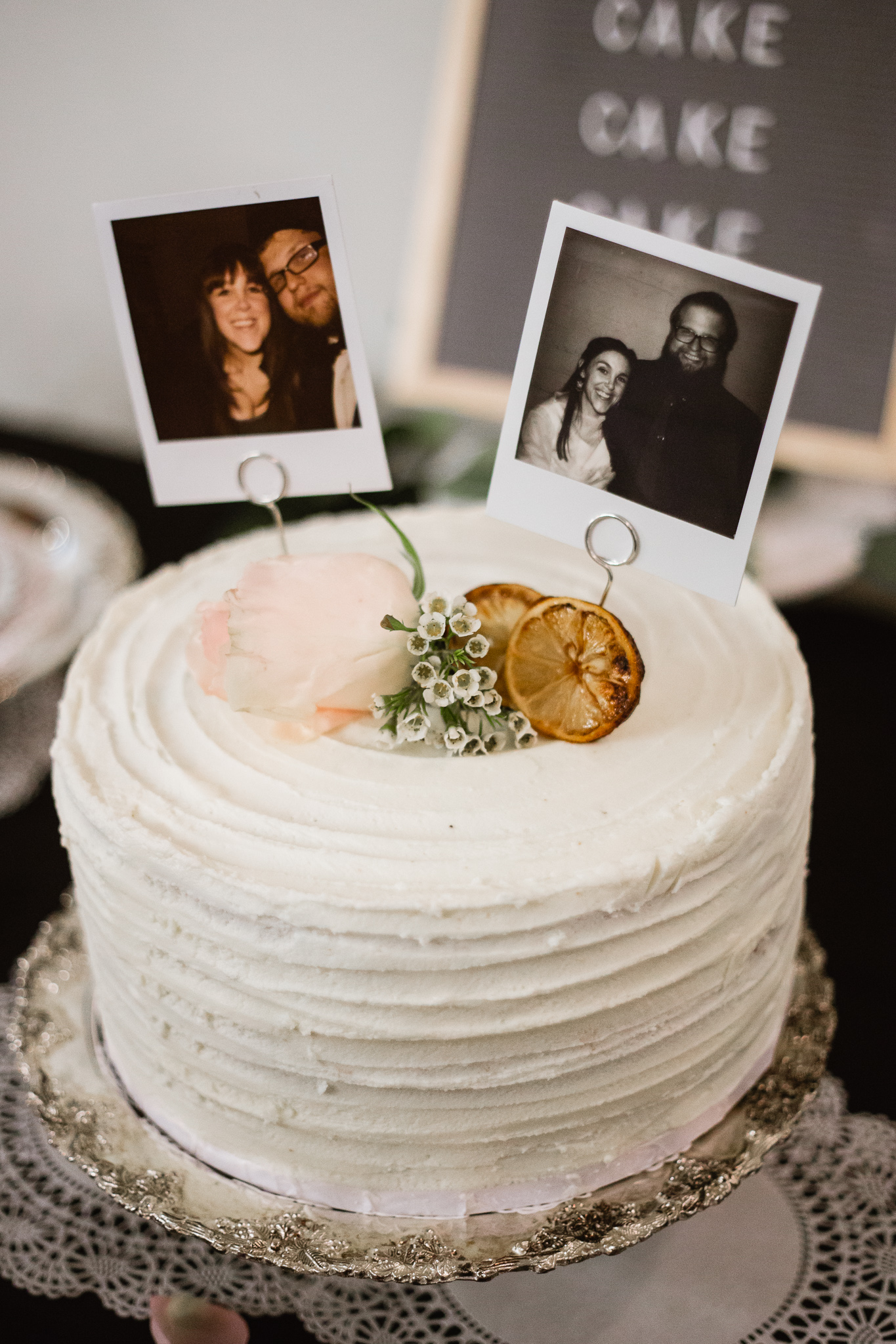 Vintage Polaroid wedding cake topper on top of orange cream cake by Bear and the Honey Phoenix.
