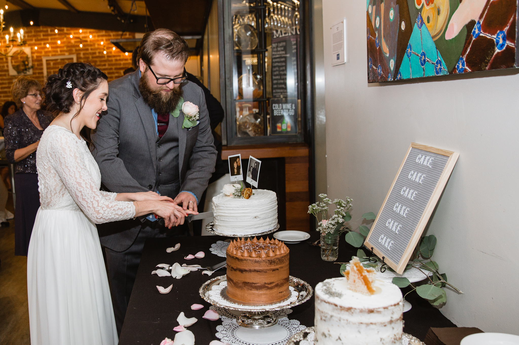 Bride and groom cutting their vintage wedding cake at their wedding reception at The Newton in Phoenix, Arizona.