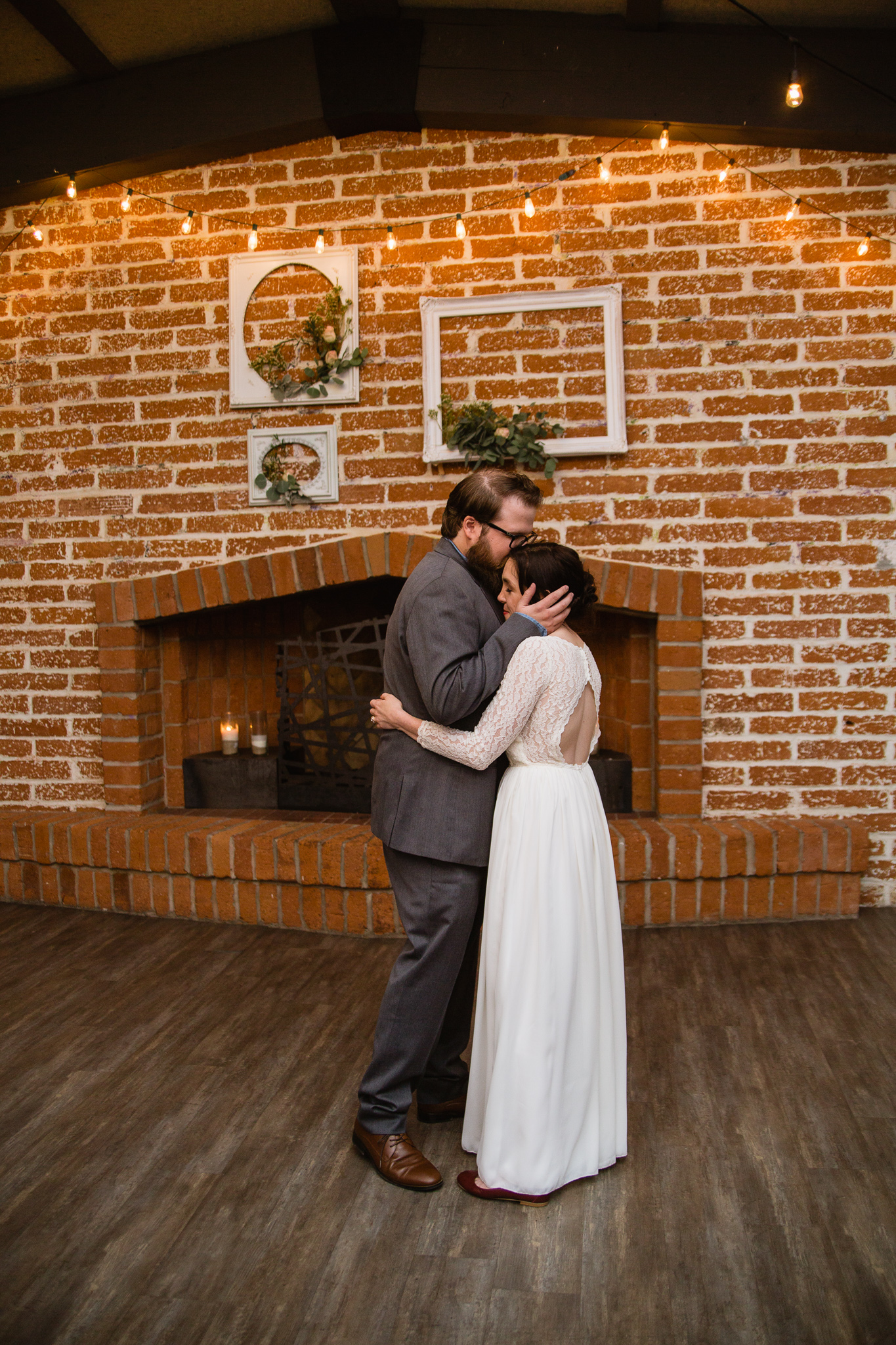 Bride and groom share an intimate moment during the first dance at their wedding reception.