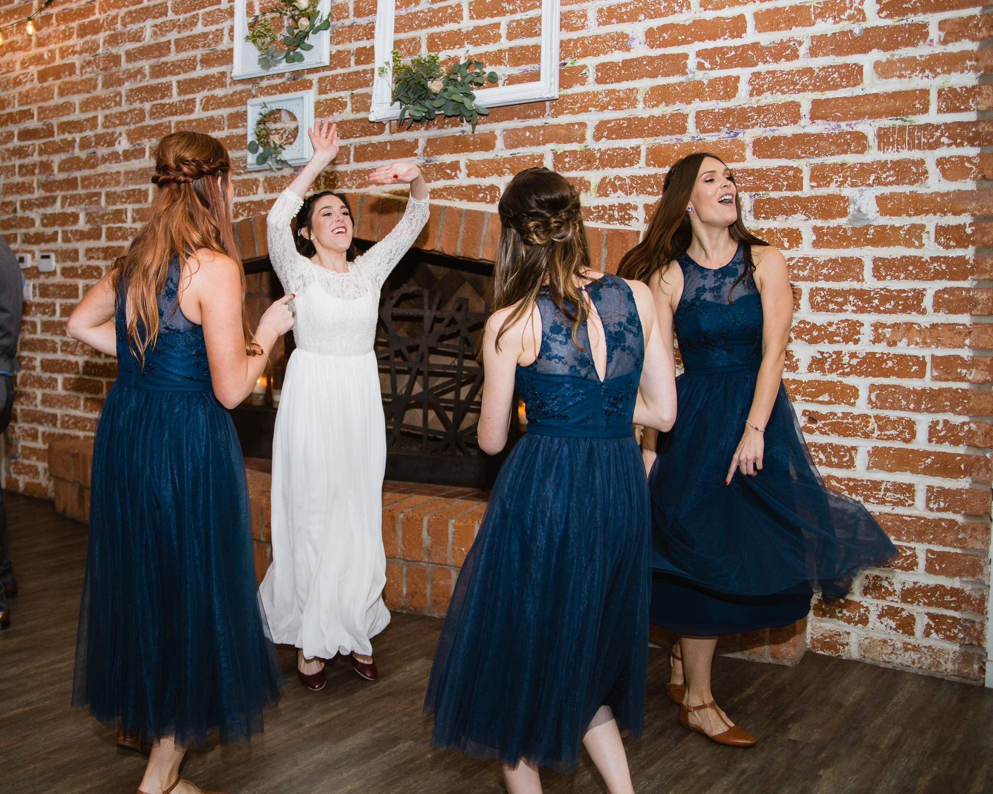 Bride dancing with bridesmaids at wedding reception at The Newton in Phoenix Arizona.