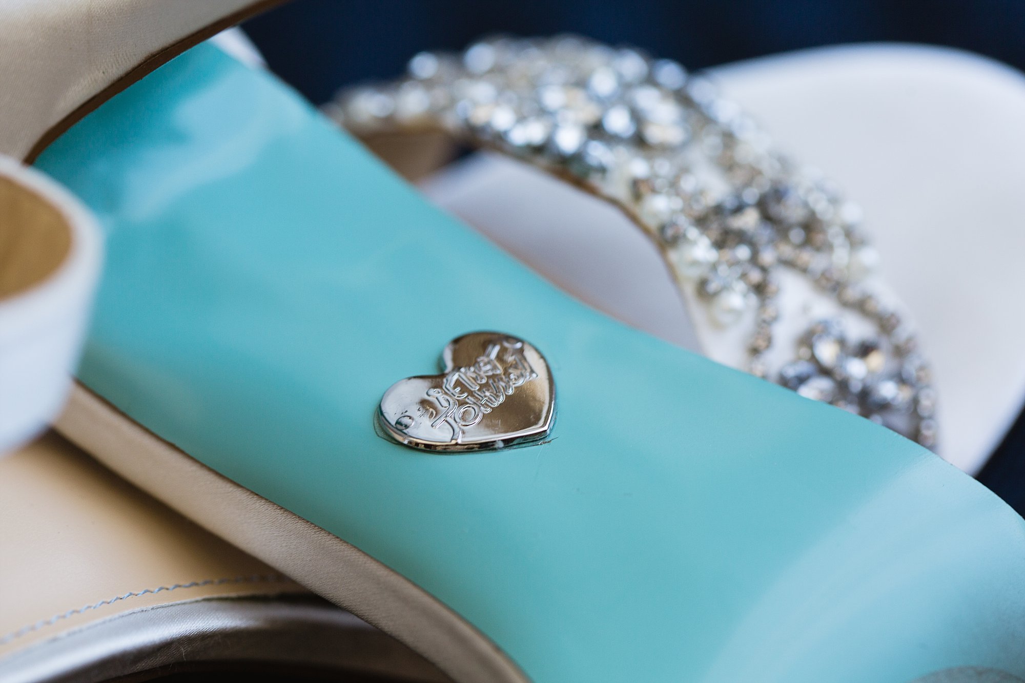 Close up image of bride's Betsy Johnson wedding shoes by wedding photographer Amber Kirchner of PMA Photography.