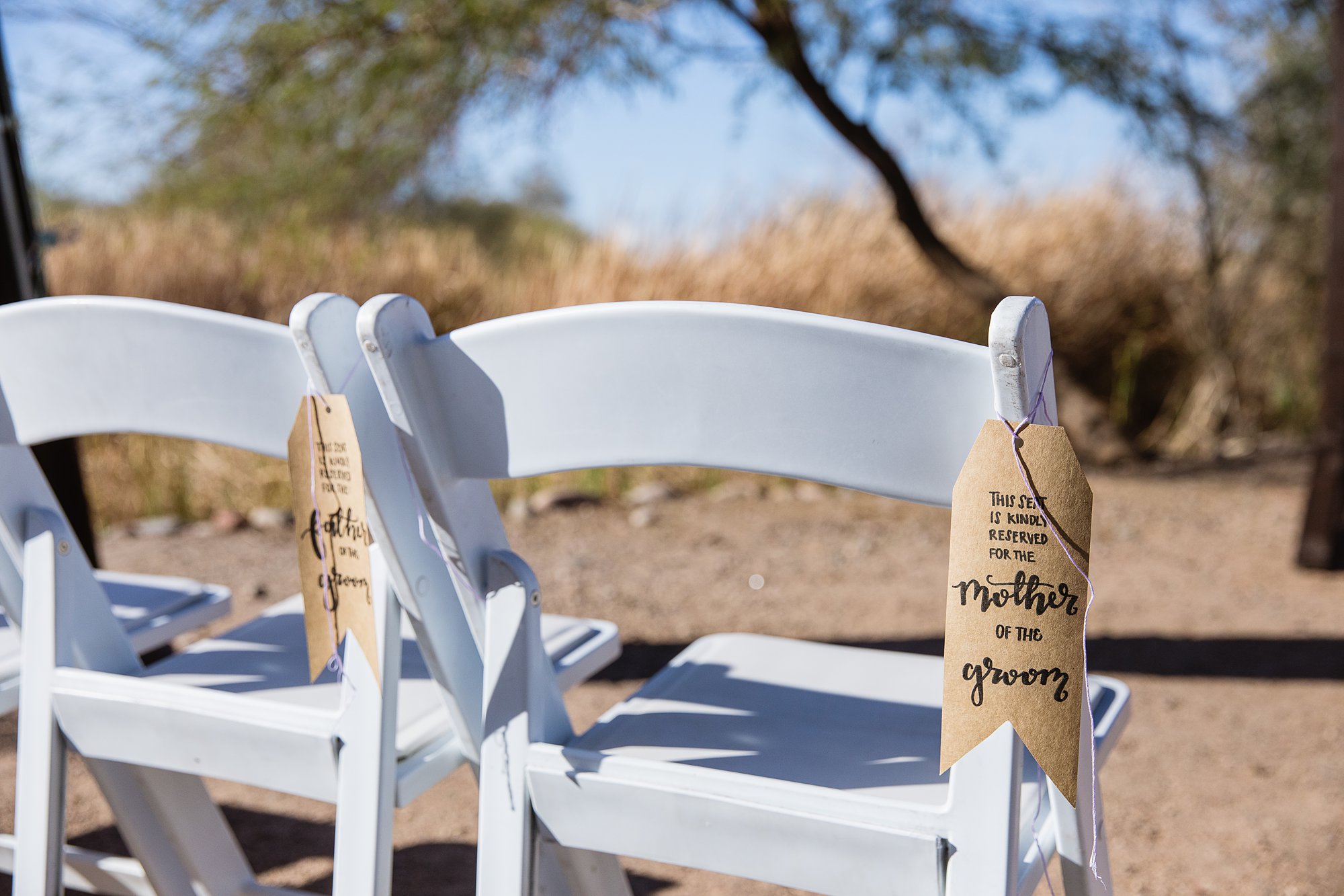 Kraft tags reserving seat for mother of the groom at a wedding ceremony.