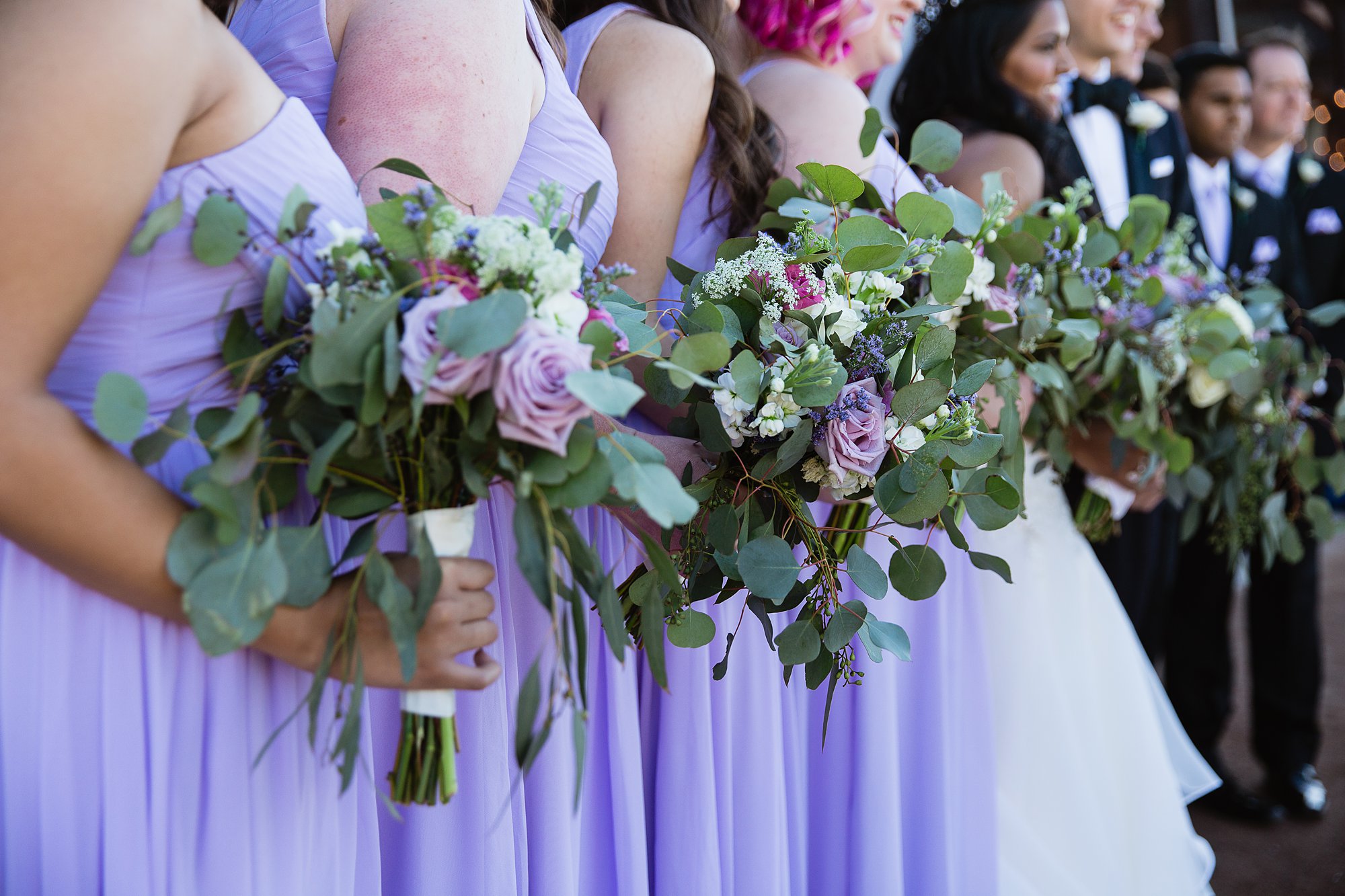 Close up image of bridesmaid's lavender bouquets.