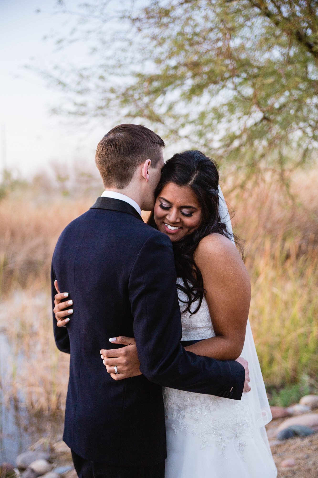 Bride reacting to the groom sharing one reason why he loves her on their wedding day.at the Rio Salado Audubon center by Phoenix wedding photographer PMA Photography.