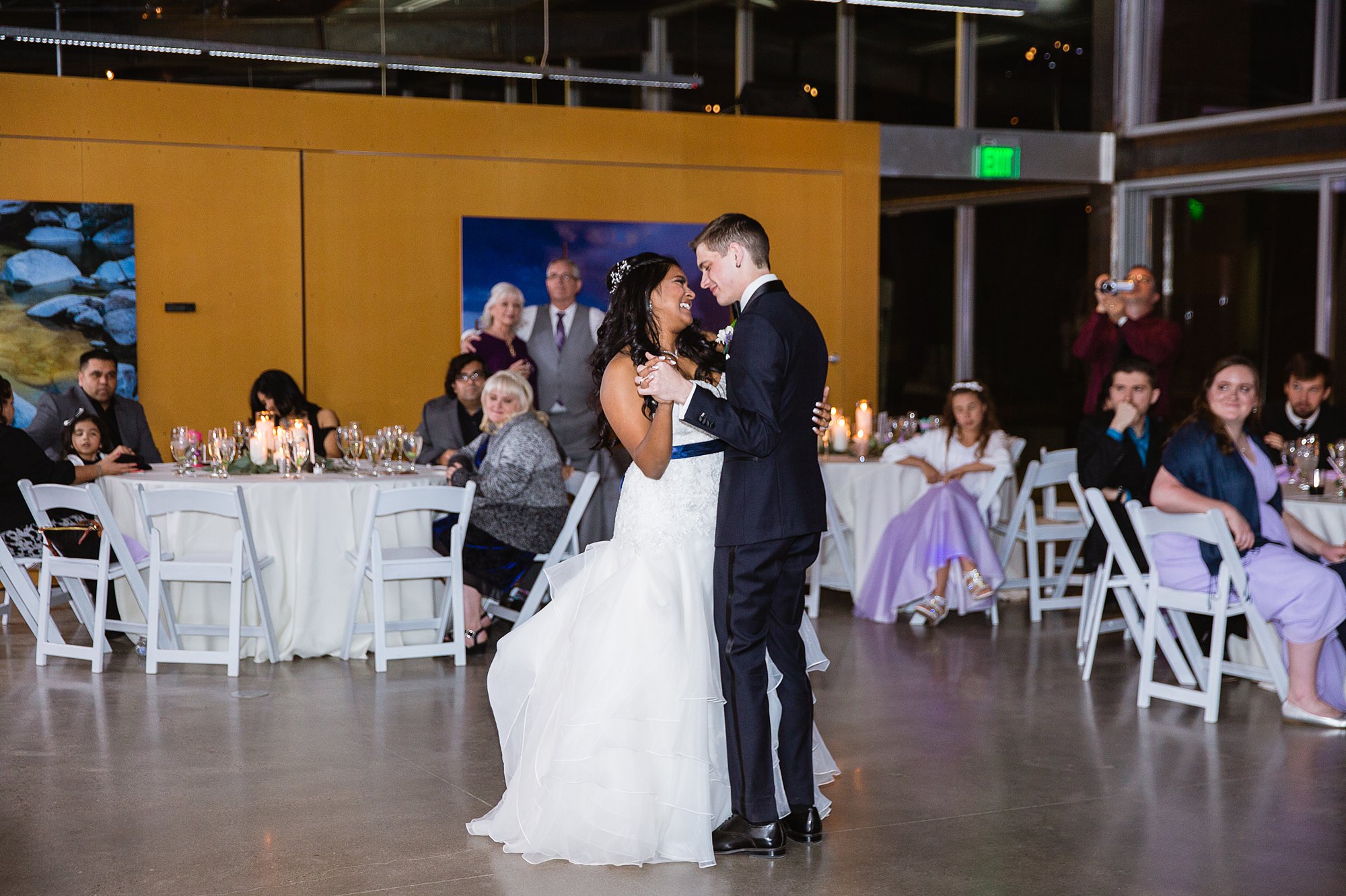 Bride and groom sharing their first dance at their wedding reception at the Rio Salado Audubon center by Phoenix wedding photographer PMA Photography.