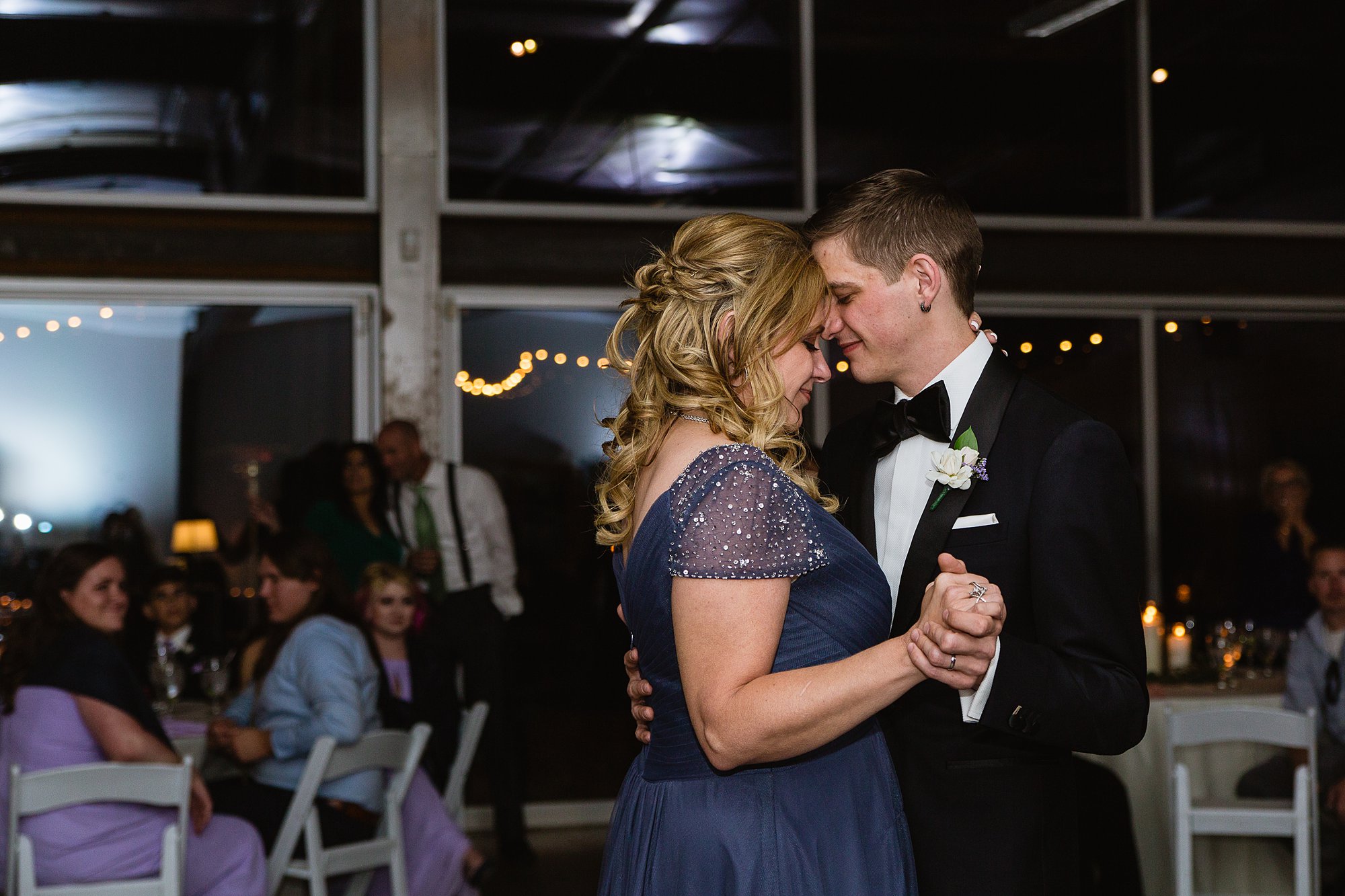 Groom and his mother during the mother son dance at his wedding reception at the Rio Salado Audubon center by Phoenix wedding photographer PMA Photography.