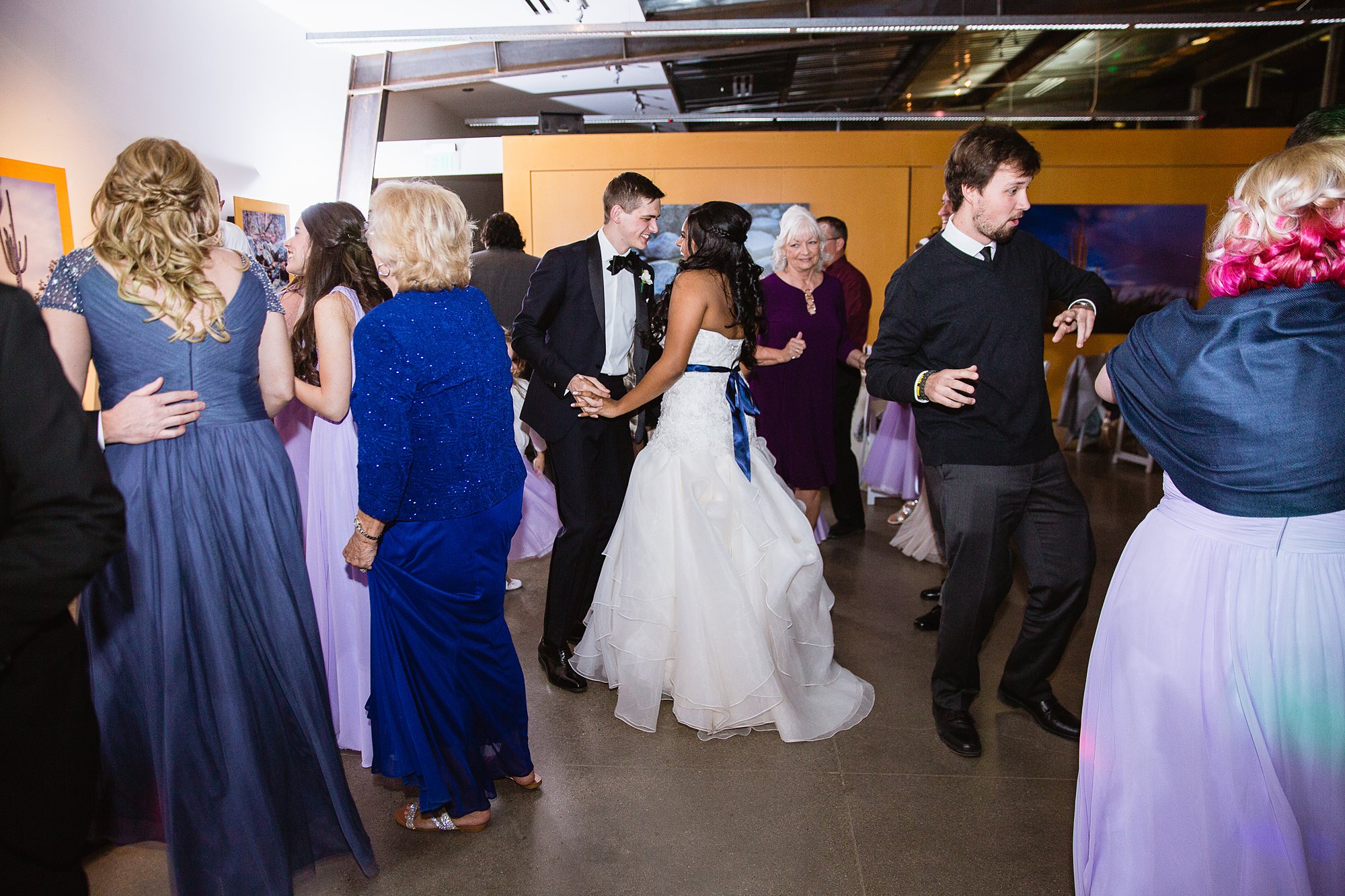 Bride and groom sharing a good luck dance with guests at the Rio Salado Audubon center by Phoenix wedding photographer PMA Photography.