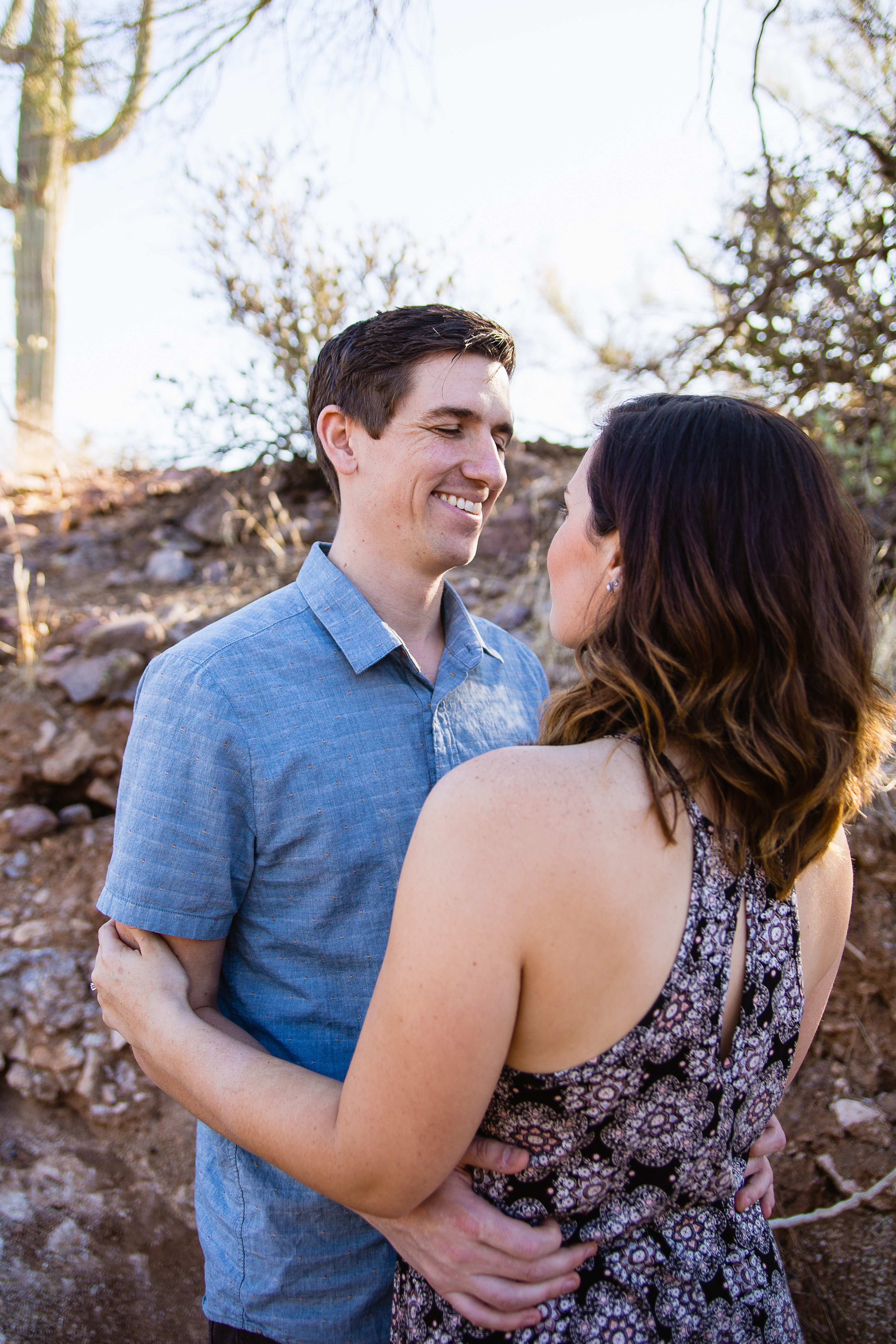 Couple making each other smile during engagement session at Lost Dutchman State Park by engagement photographer PMA Photography.