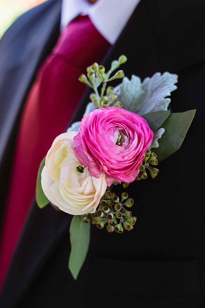 Pink and white ranunculus boutonniere by PMA Photography.