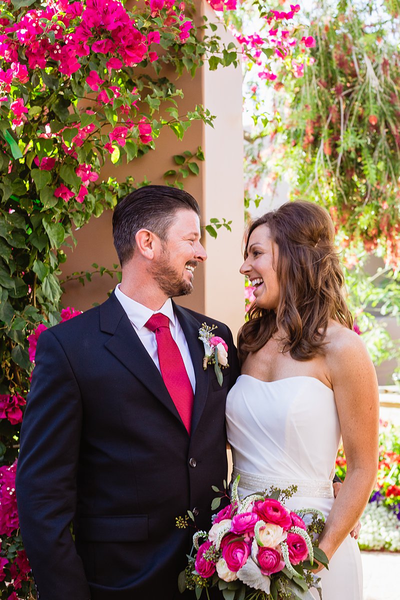 Classic pink bride and groom laugh with each other by Phoenix wedding photographer PMA Photography.