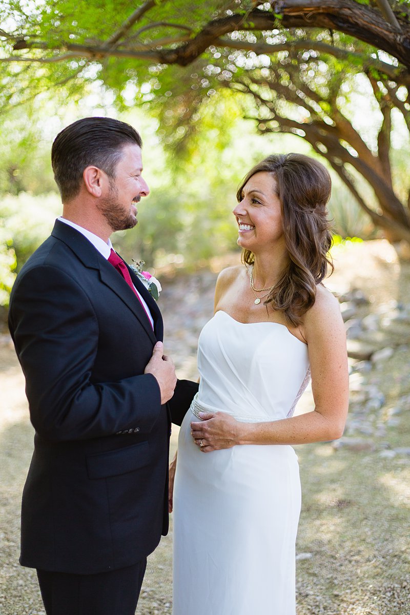 Classic styled bride and groom smile at each other at Hermosa Inn by Phoenix wedding photographer PMA Photography.