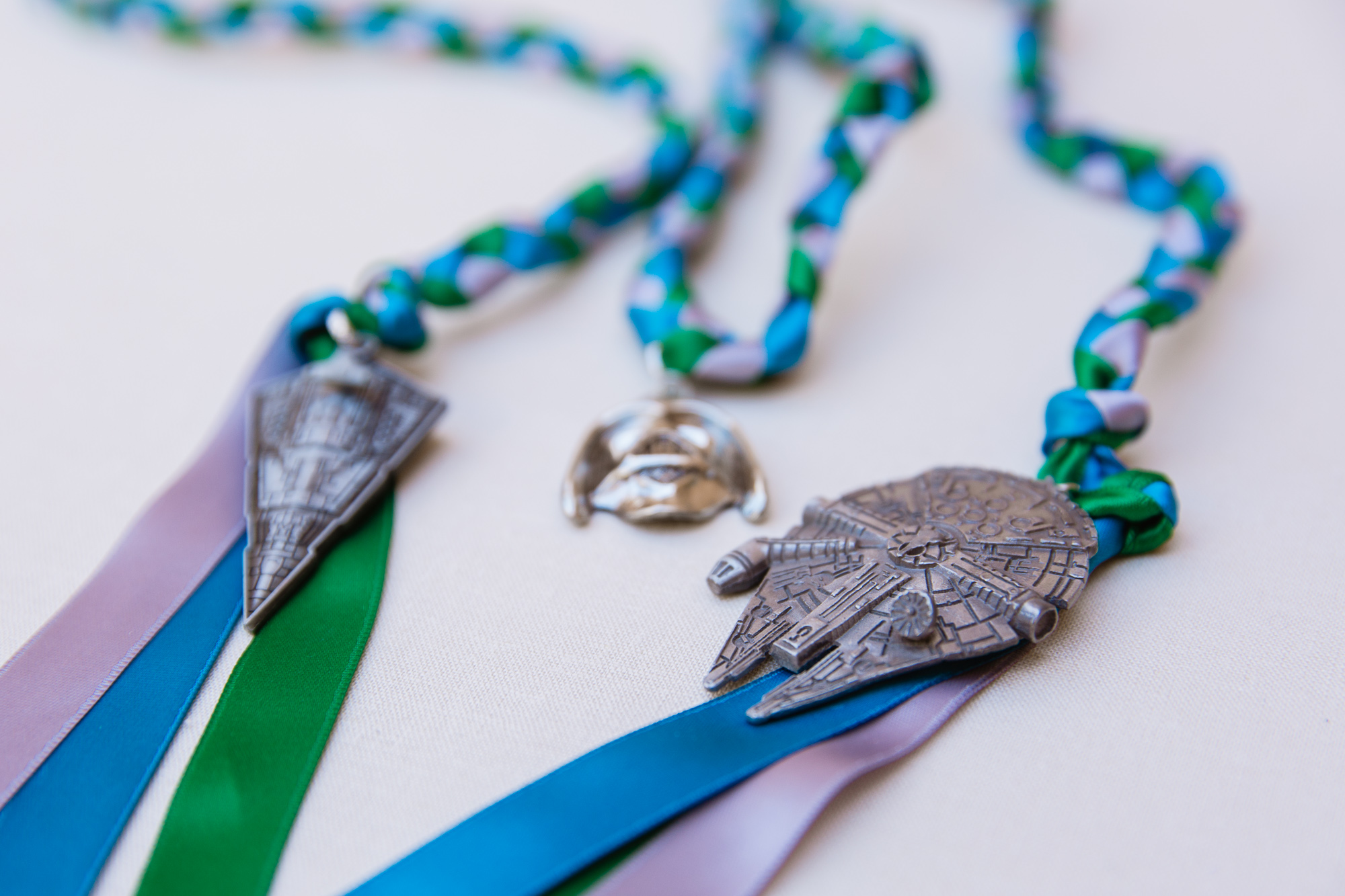 Star Wars charms on blue green and grey handfasting chords by Phoenix wedding photographer PMA Photography.