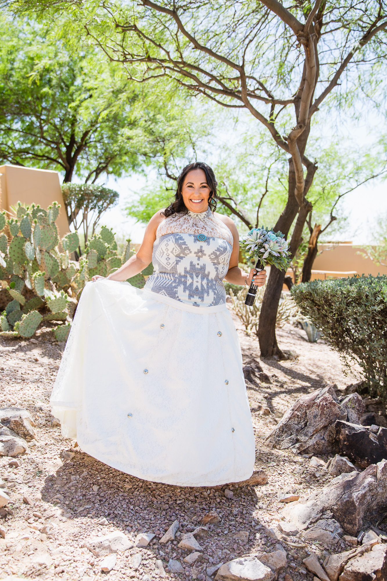 Bride in a Navajo designed wedding dress with turquoise Star Wars bouquet by Arizona wedding photographers PMA Photography.