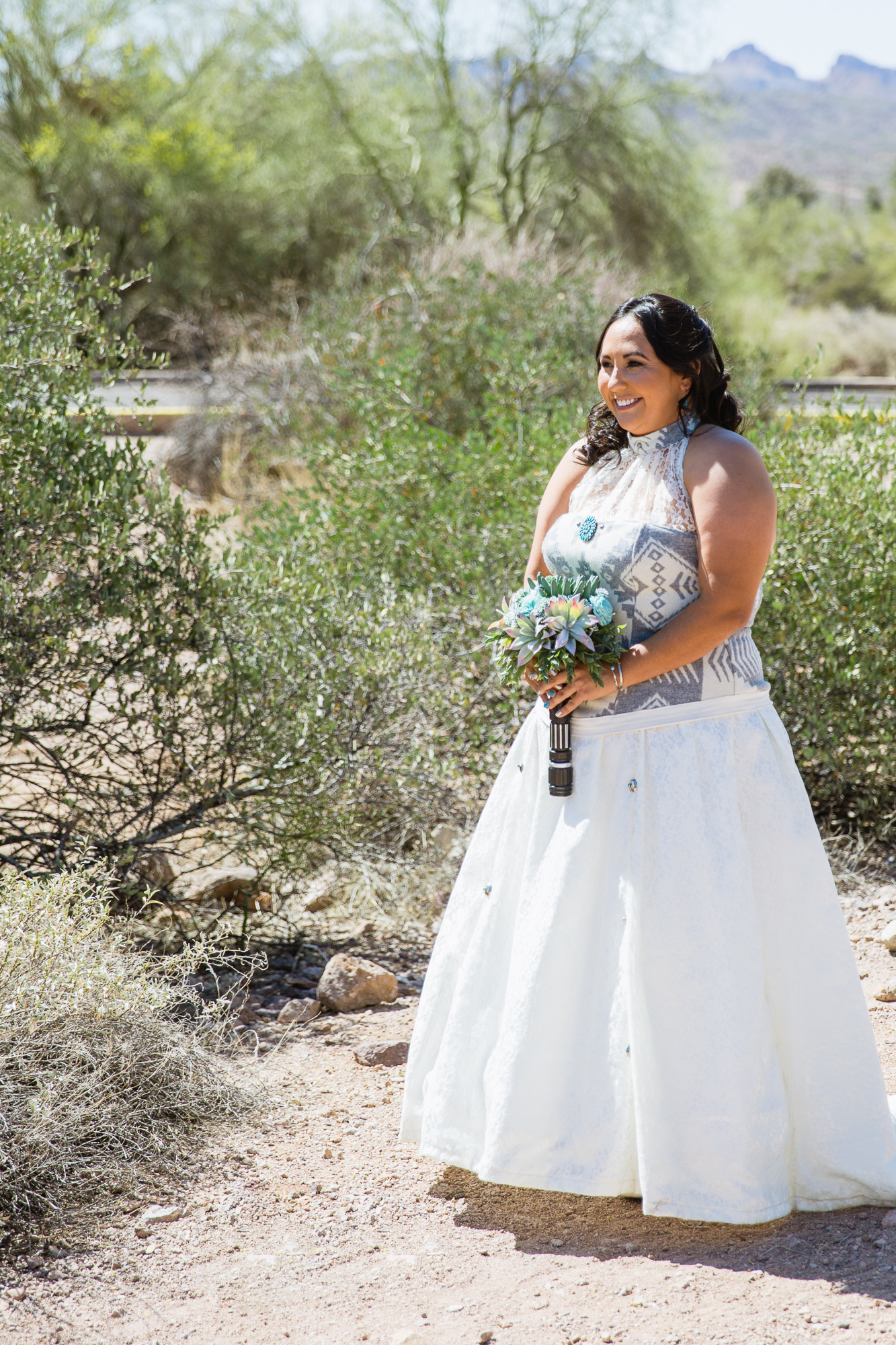 Bride seeing her groom for the first time during their first look at Lost Dutchman state park by wedding photographer PMA Photography.