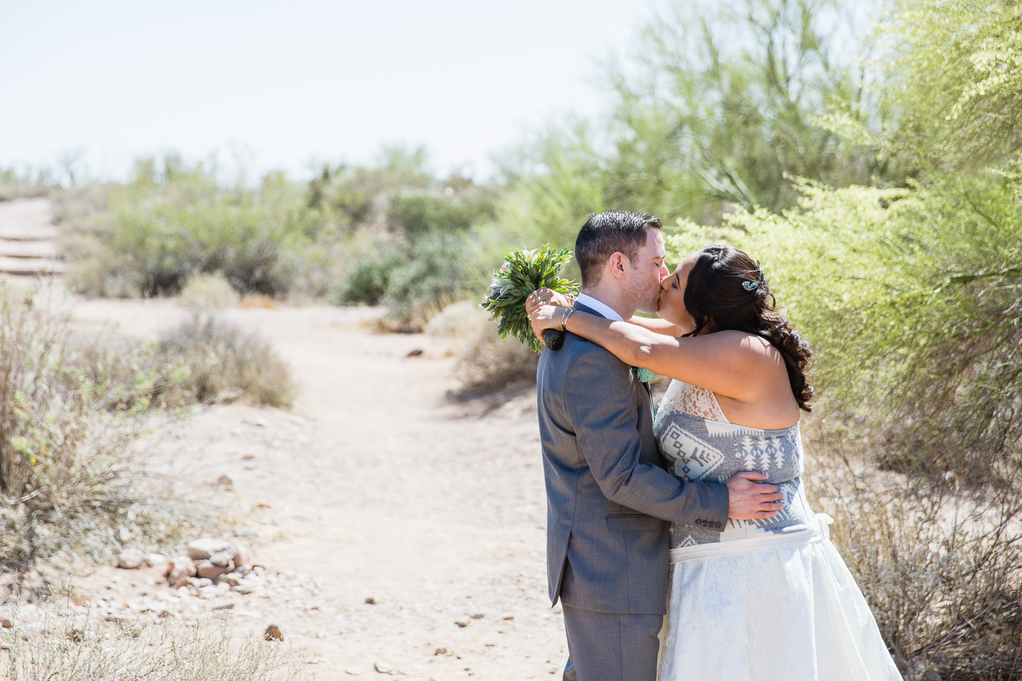 Bride and groom during their first look at Lost Dutchman state park by wedding photographer PMA Photography.