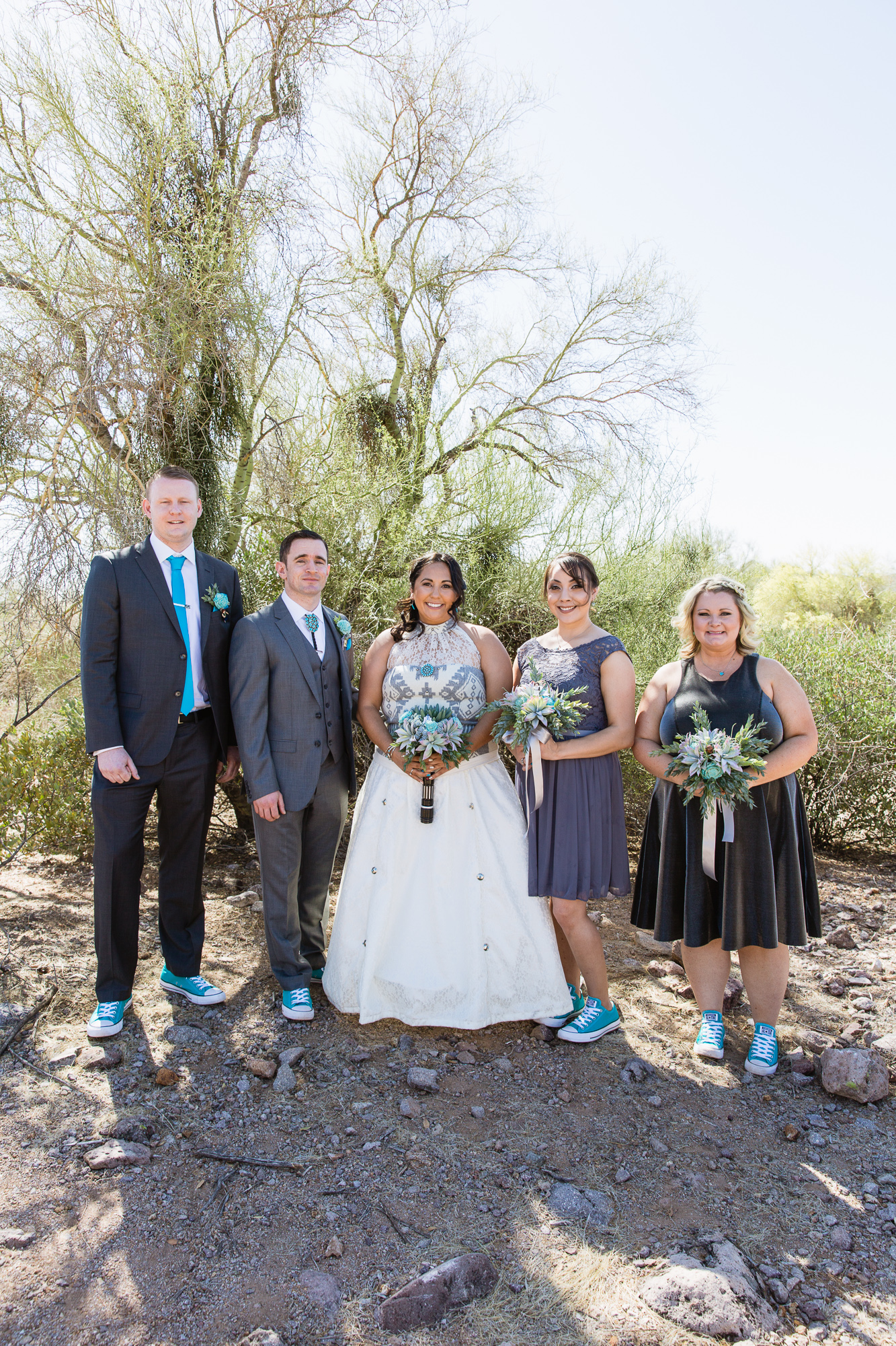 Turquoise and Grey bridal party in the Arizona desert of Lost Dutchman State Park by wedding photographer PMA Photography.