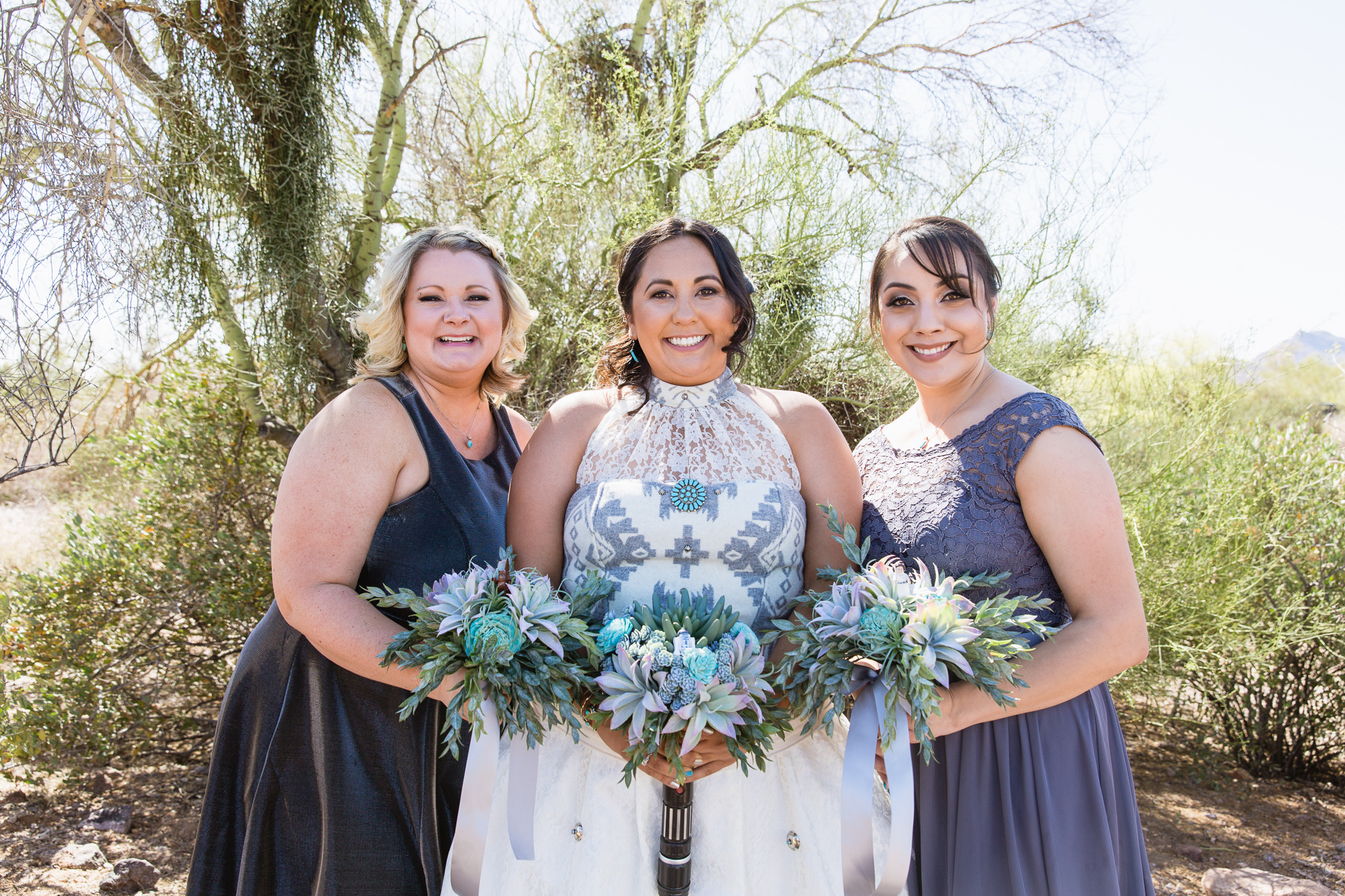 Grey and turquoise bridesmaids with bride in the Arizona desert by wedding photography by PMA Photography.